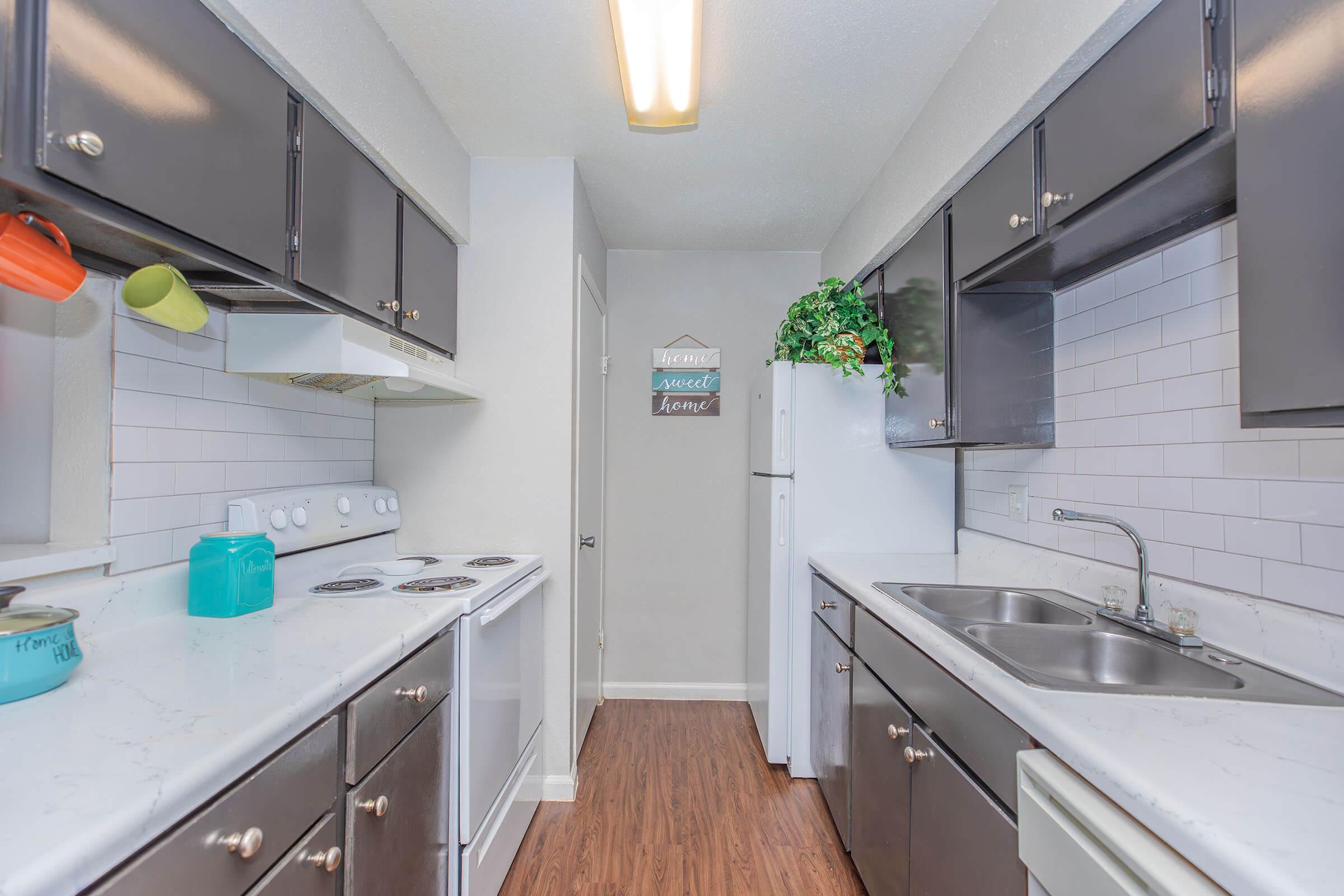 a kitchen with a sink and a mirror