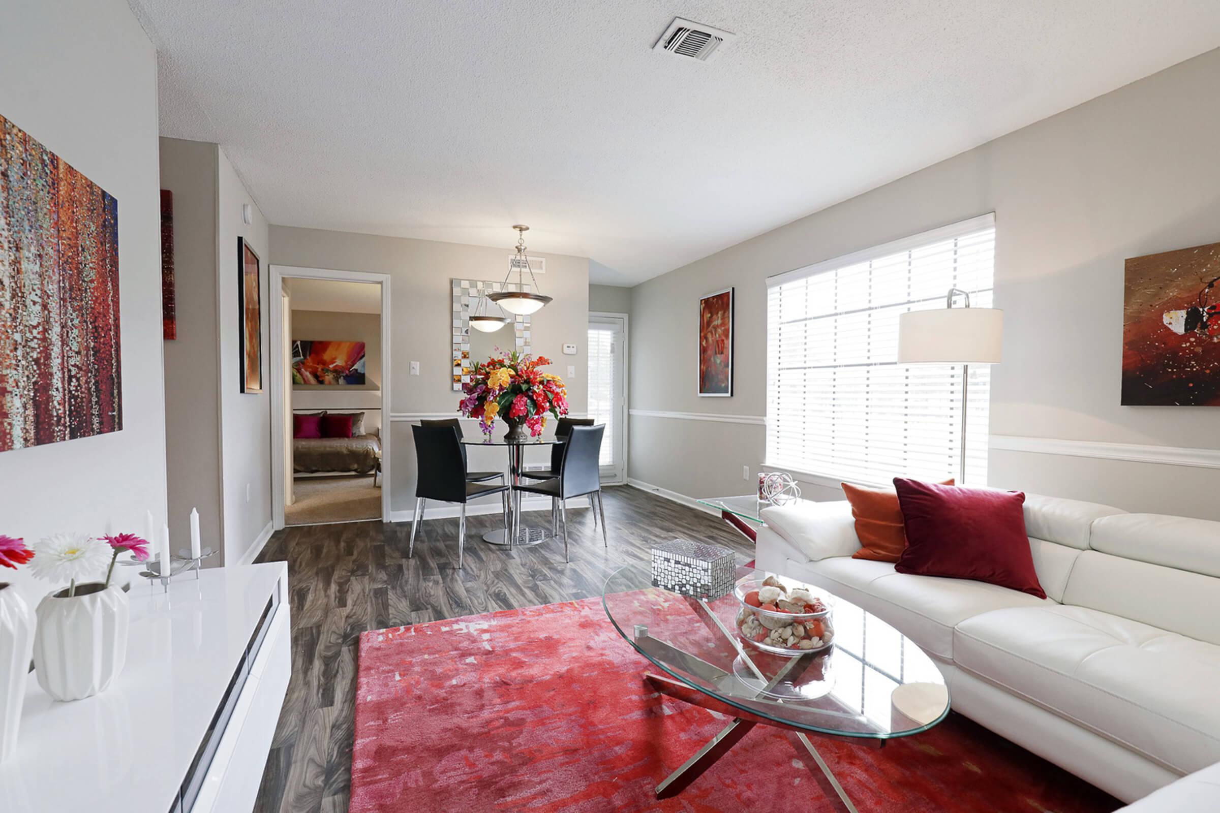 a living room filled with furniture and a flat screen tv