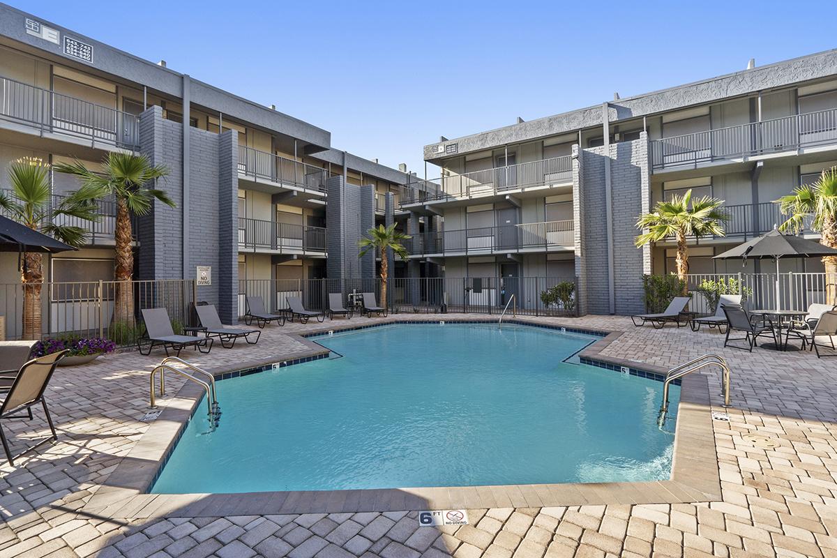 a house with a pool in front of a building