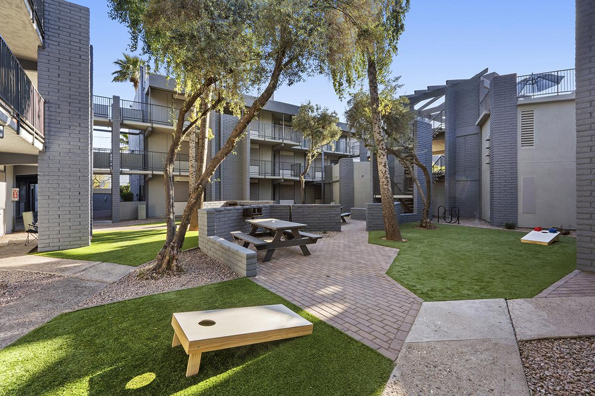 a large lawn in front of a brick building