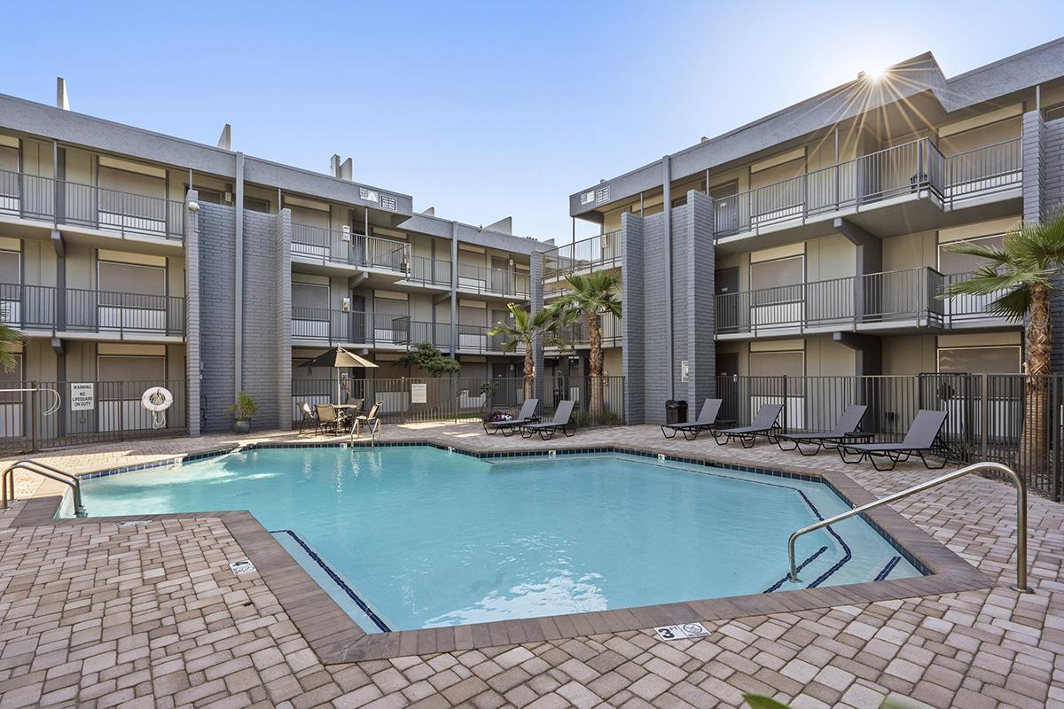 a large brick building with a pool in front of a house