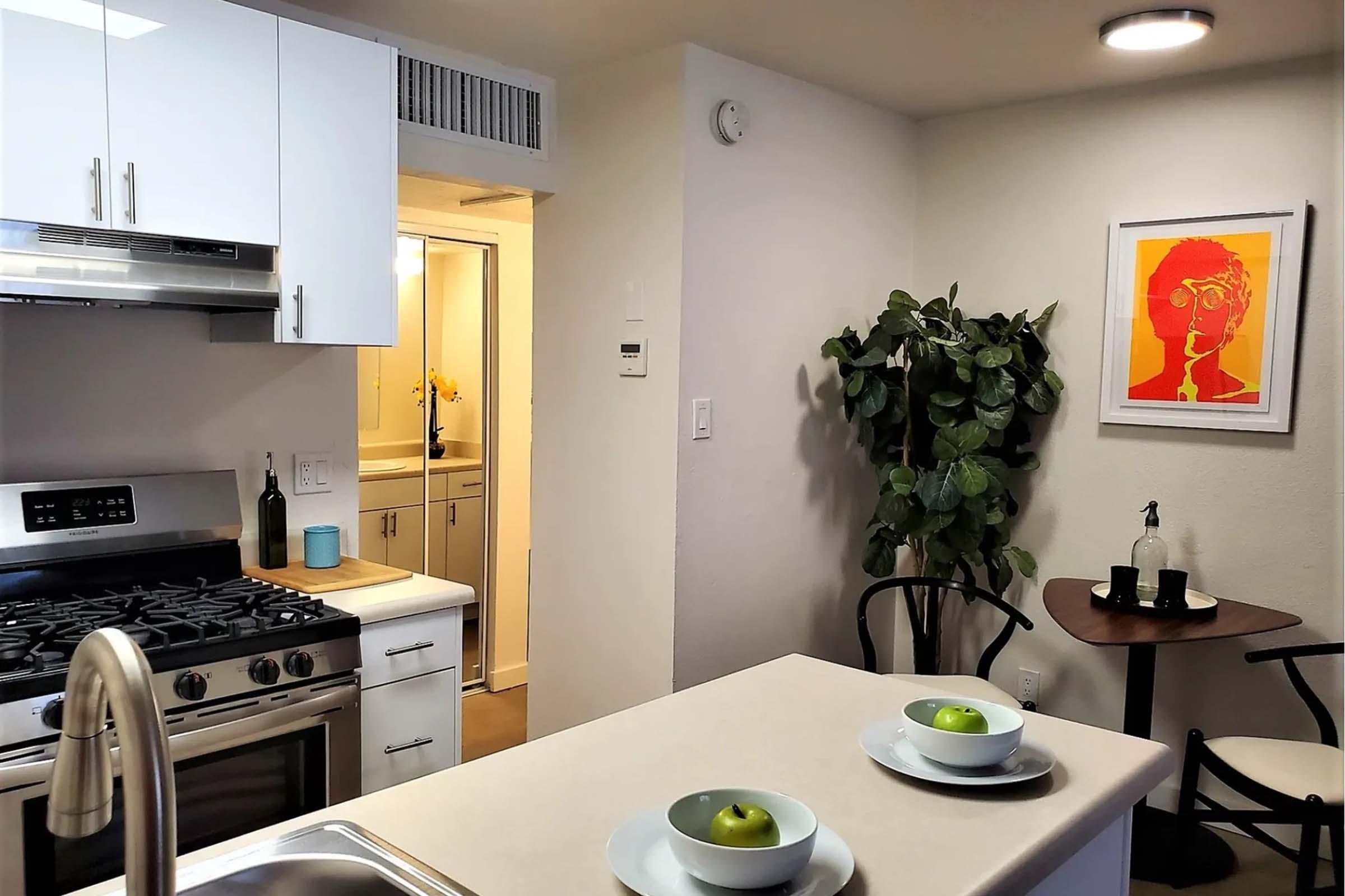 a modern kitchen with an island in the middle of a room