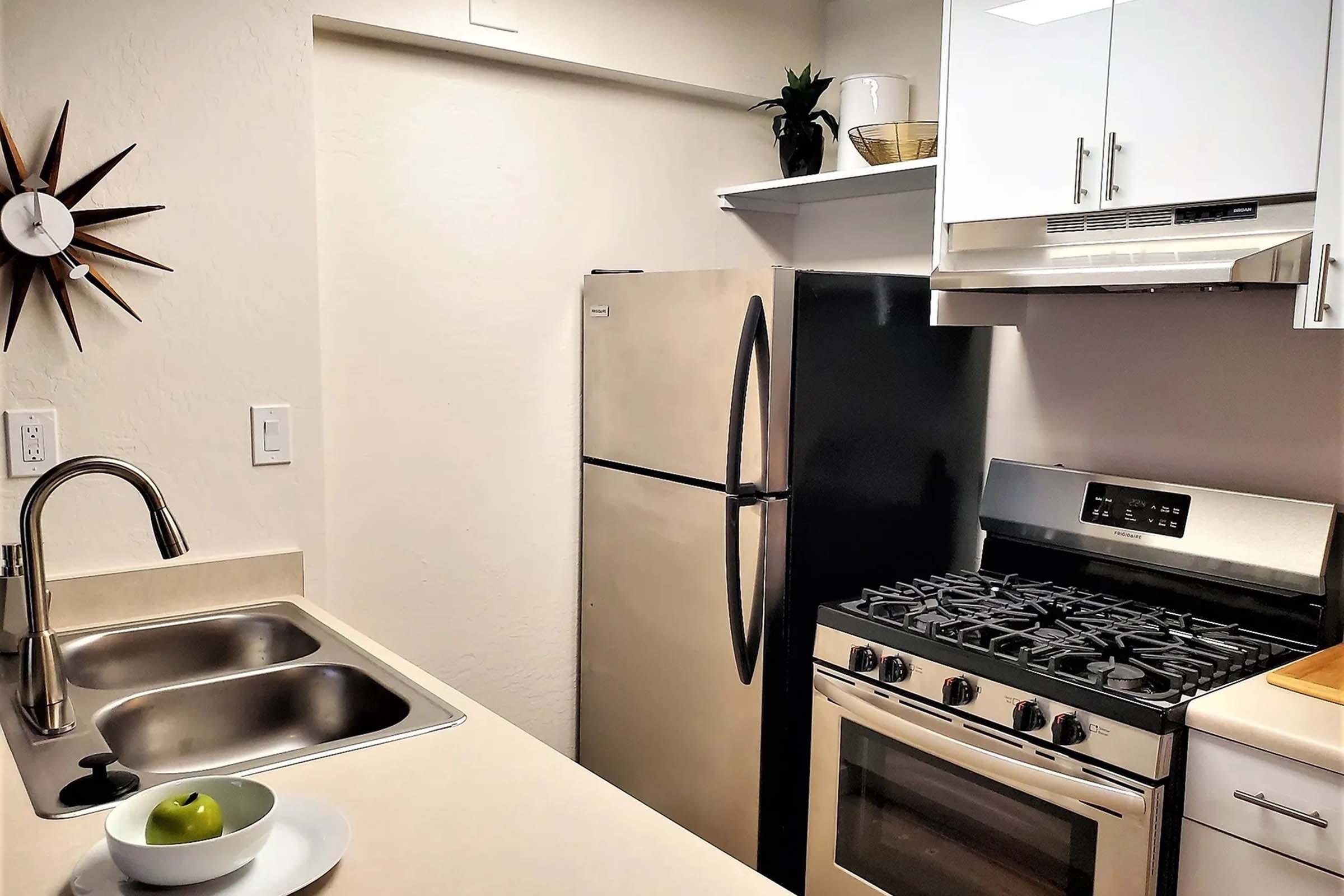 a stove top oven sitting inside of a kitchen