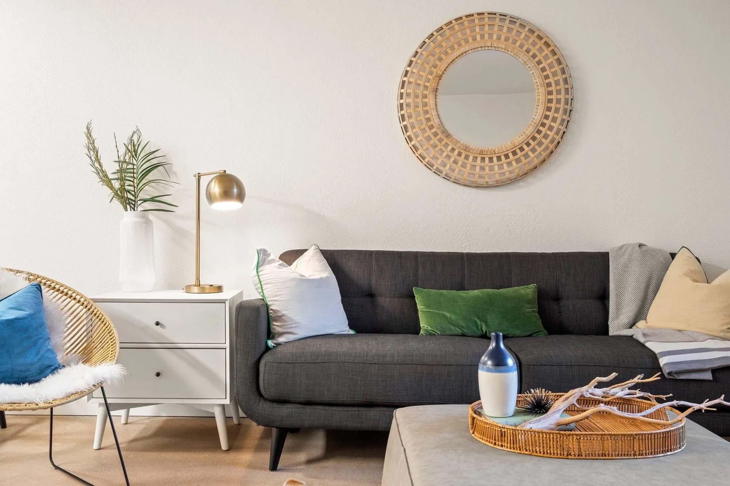 a living room filled with furniture and a lamp