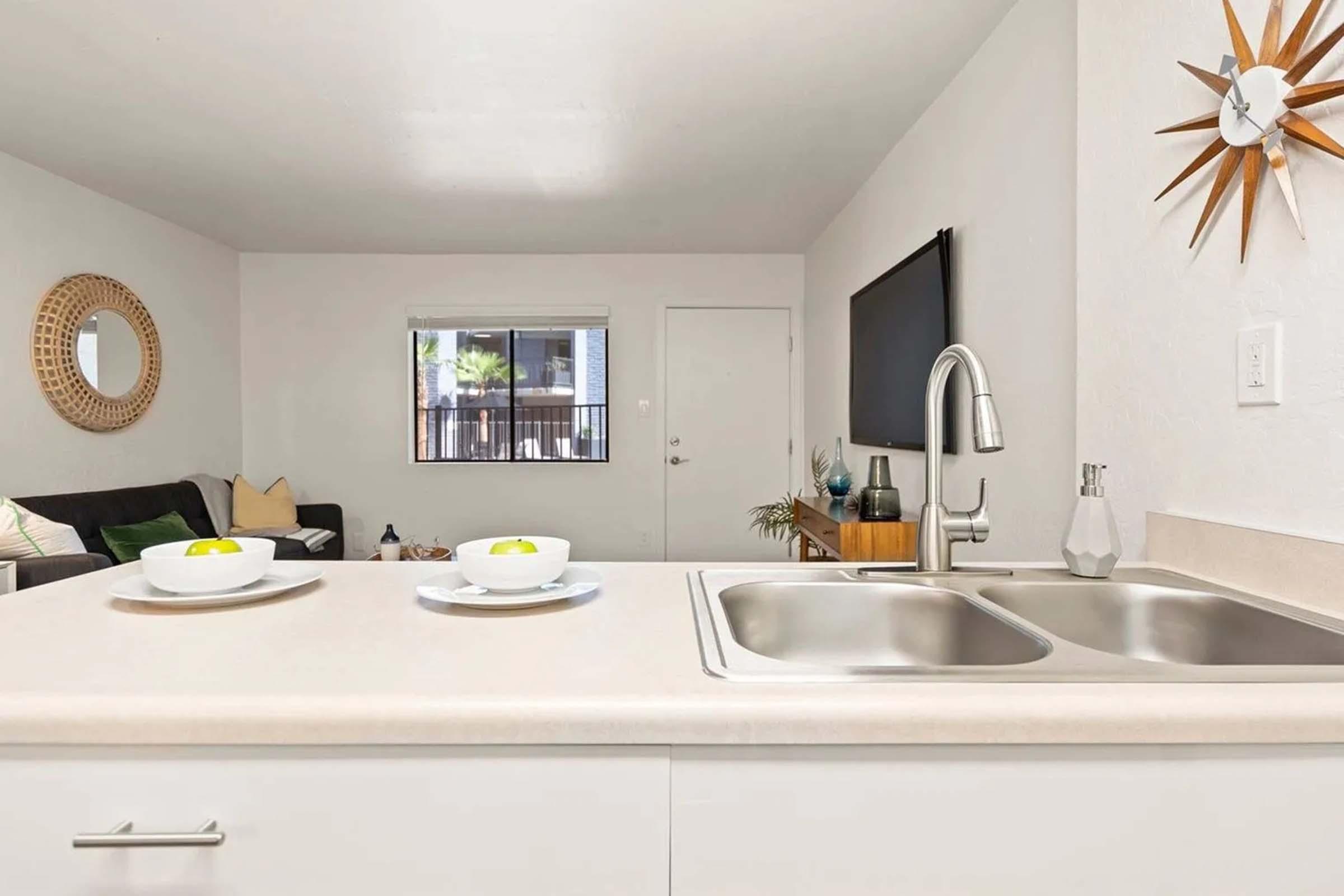 a kitchen with a sink and a mirror