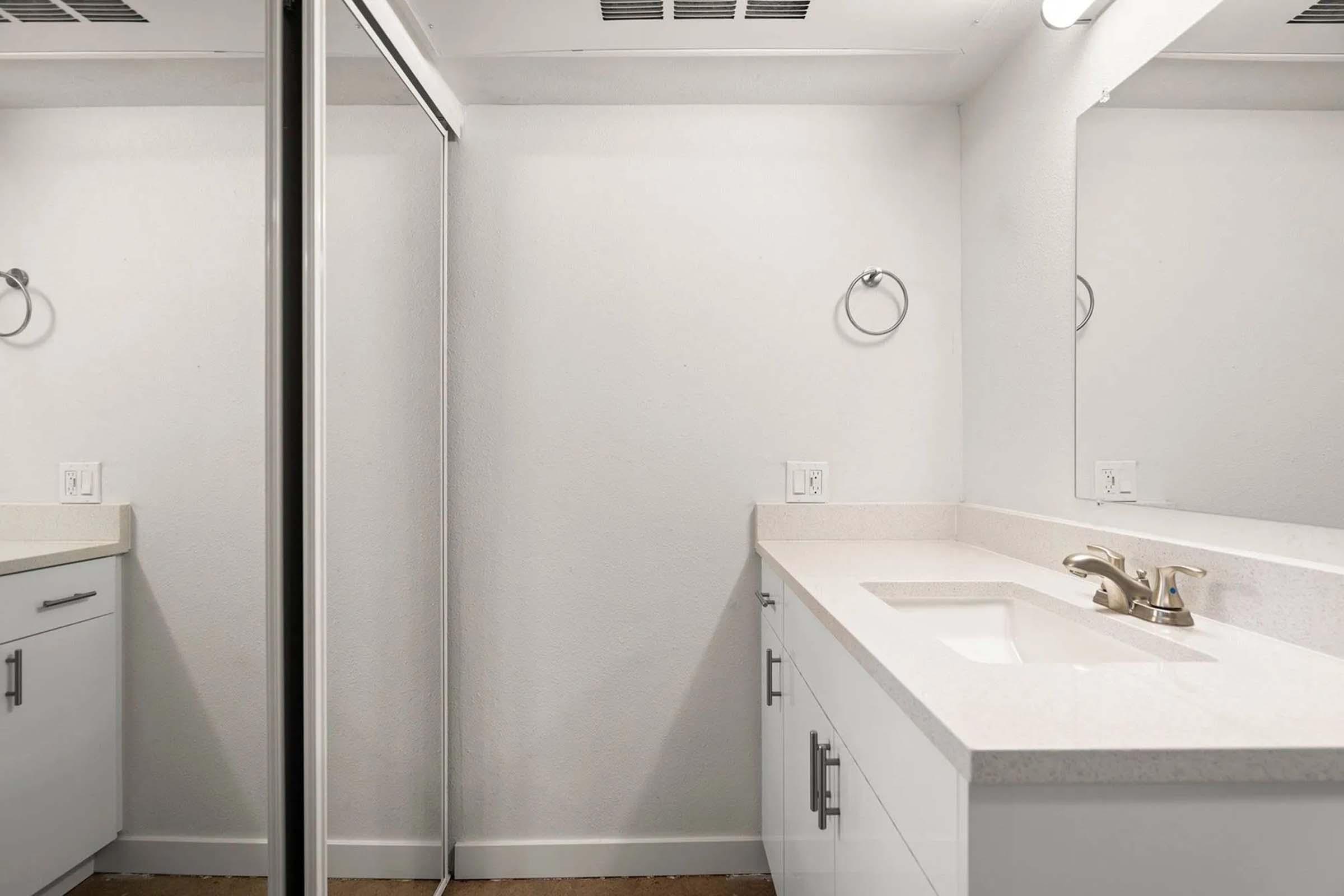 a sink sitting under a mirror