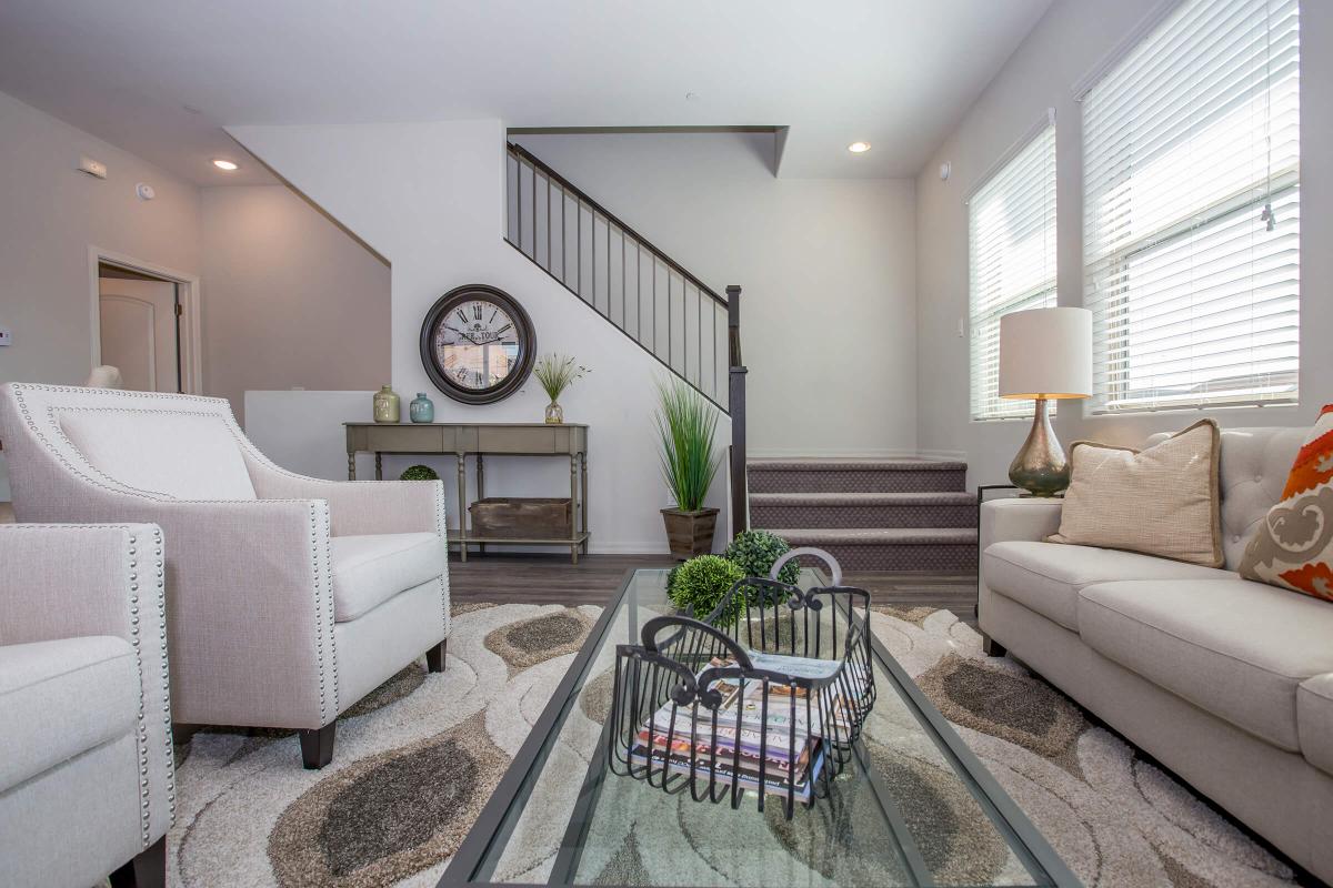 a living room filled with furniture and a flat screen tv