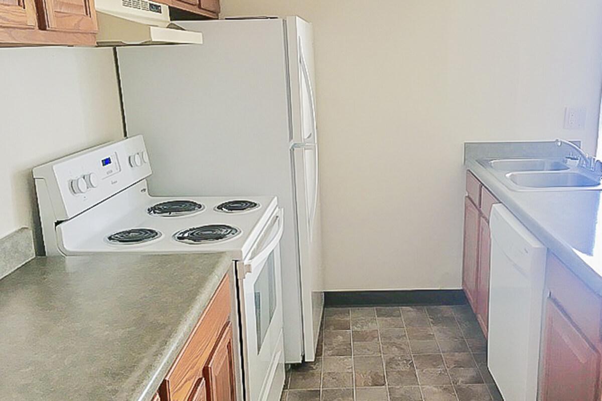 a kitchen with a white stove top oven sitting inside of a refrigerator