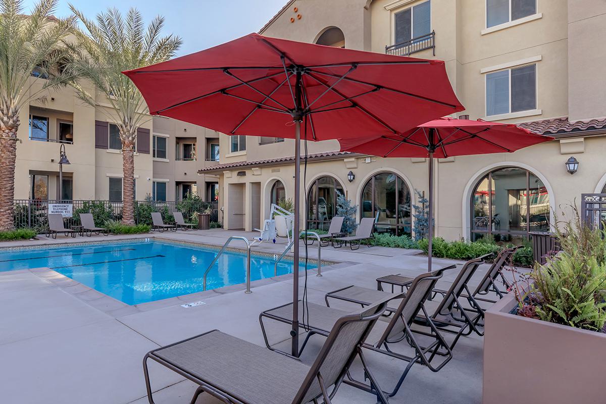 The community pool with a row of chairs