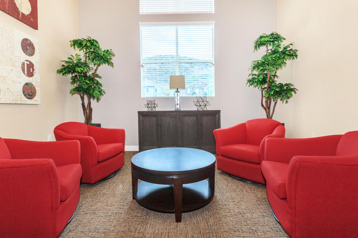 A community room with red chairs