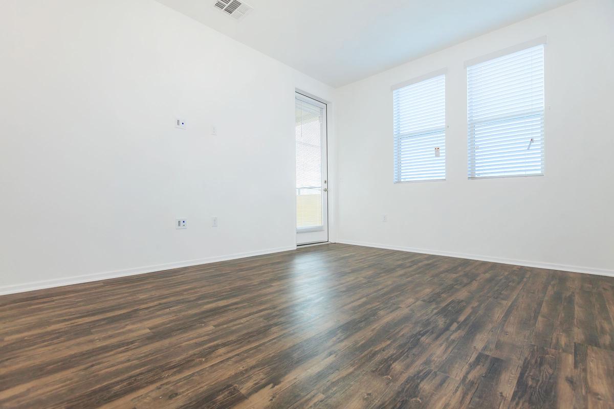 Unfurnished living room with wooden floors