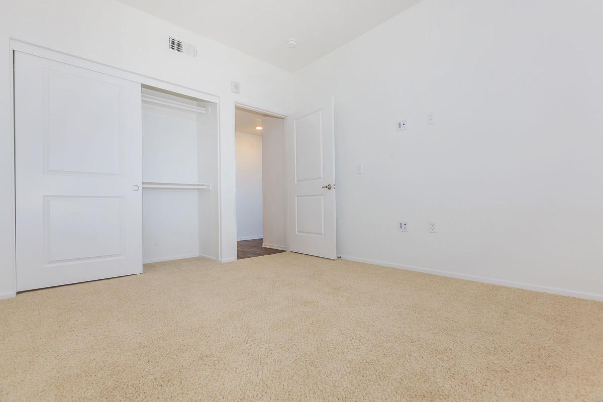 Unfurnished bedroom with open sliding closet door