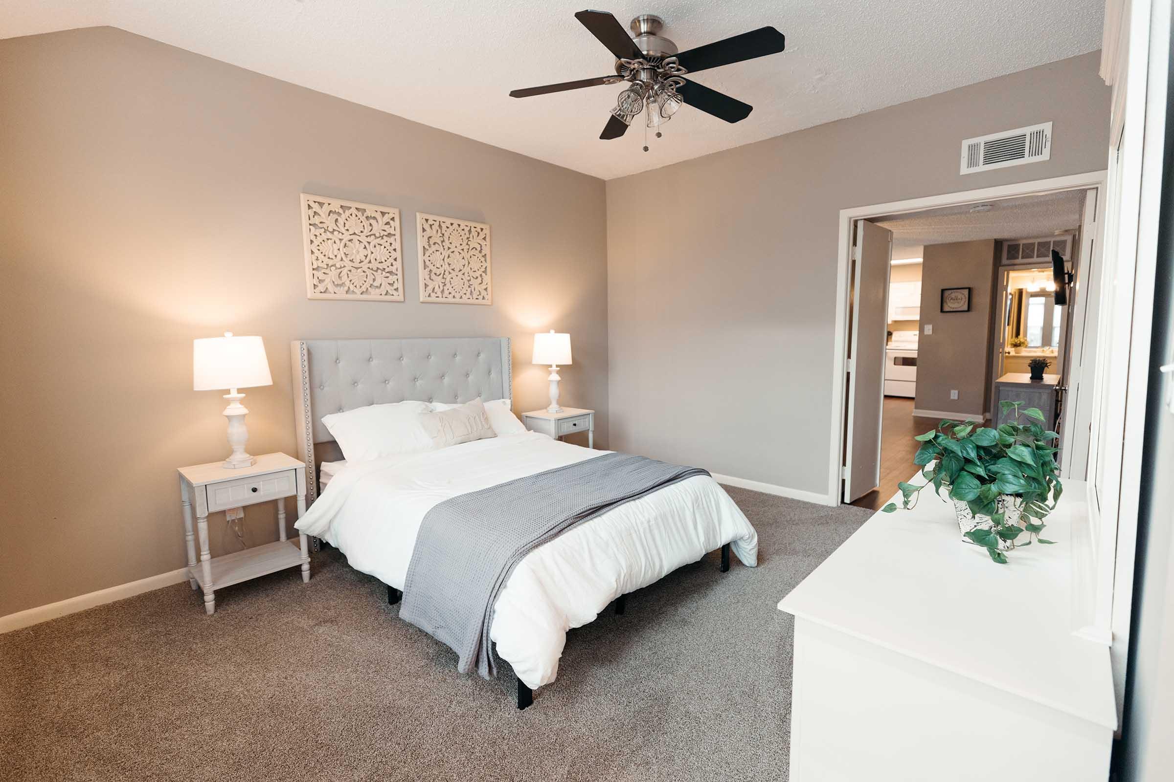 a bedroom with a bed and desk in a room