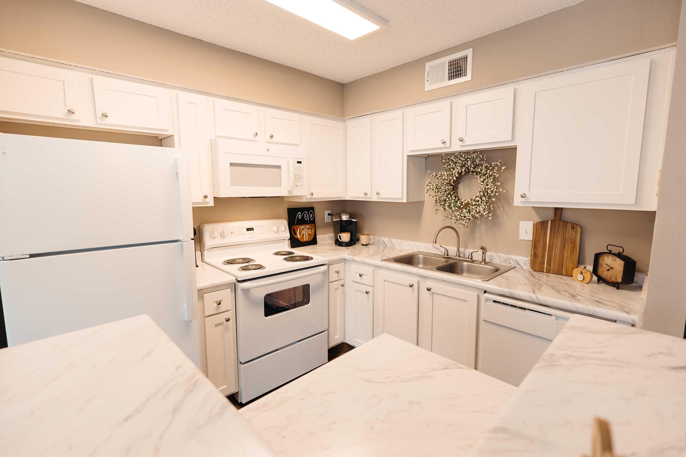 a kitchen with a stove and a refrigerator