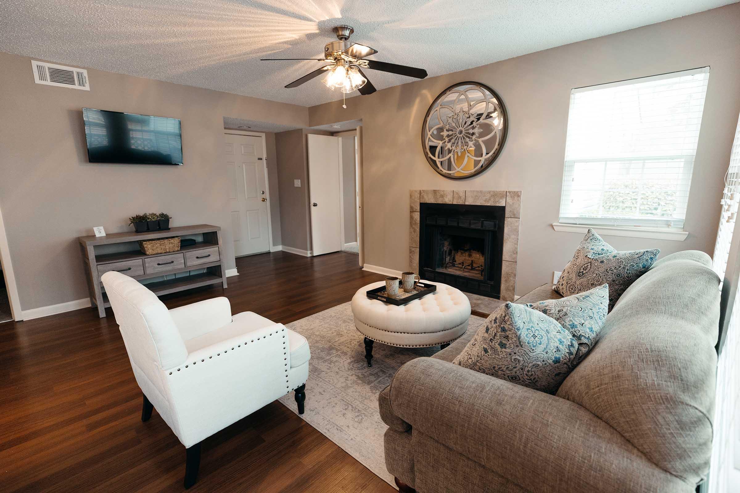 a living room filled with furniture and a flat screen tv