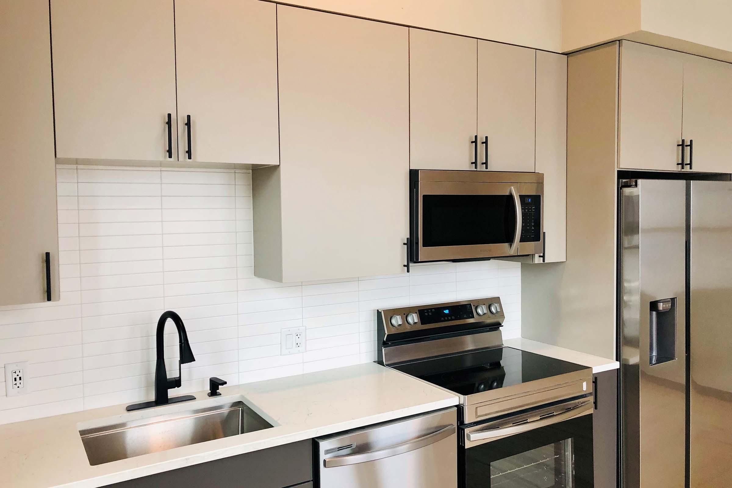 a kitchen with a sink and a microwave