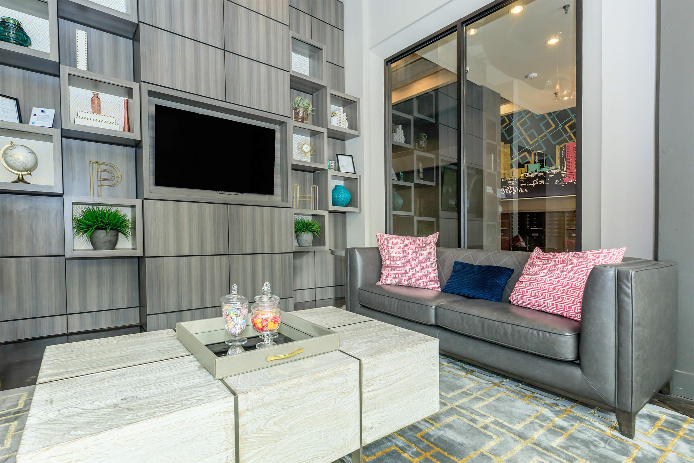 a living room filled with furniture and a large window