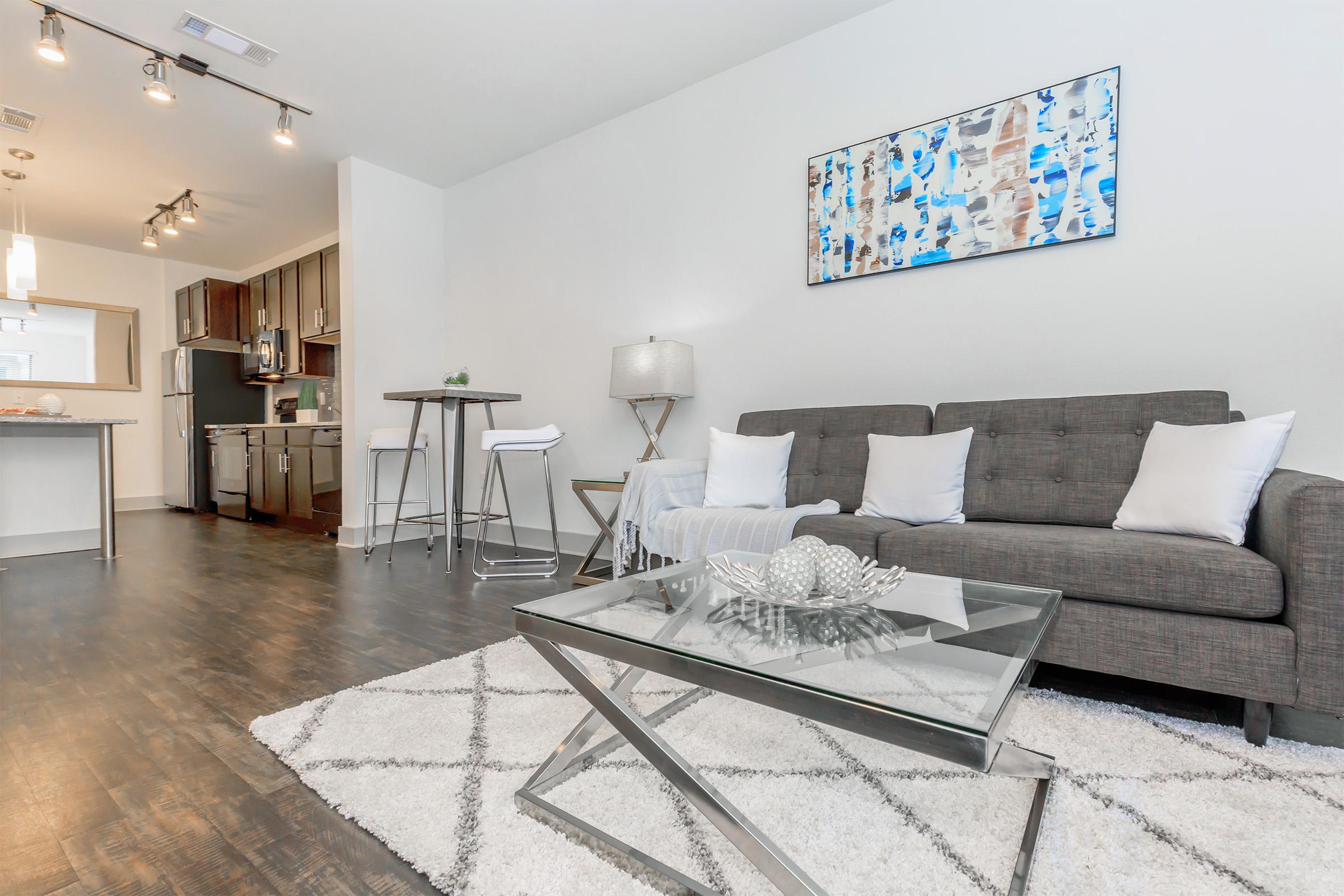 a living room filled with furniture and a rug