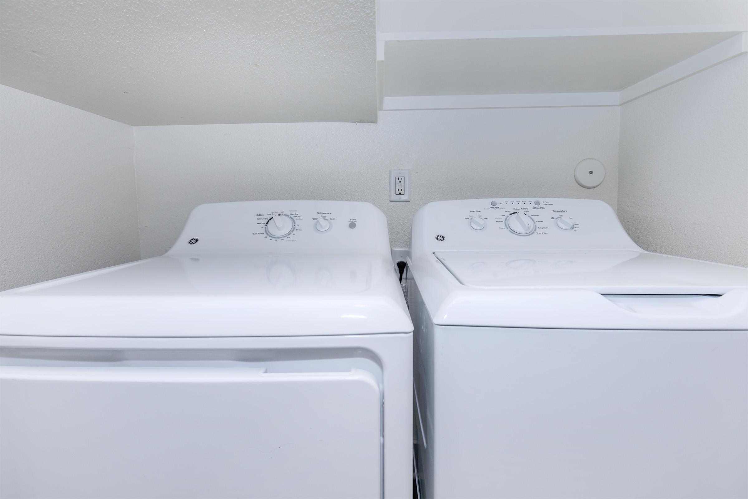 a white sink sitting under a microwave