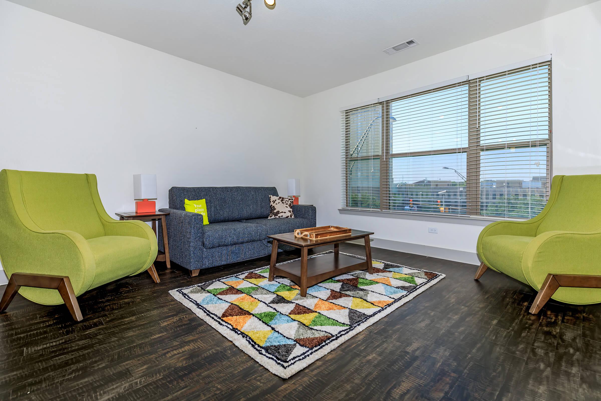 a living room filled with furniture and a large window