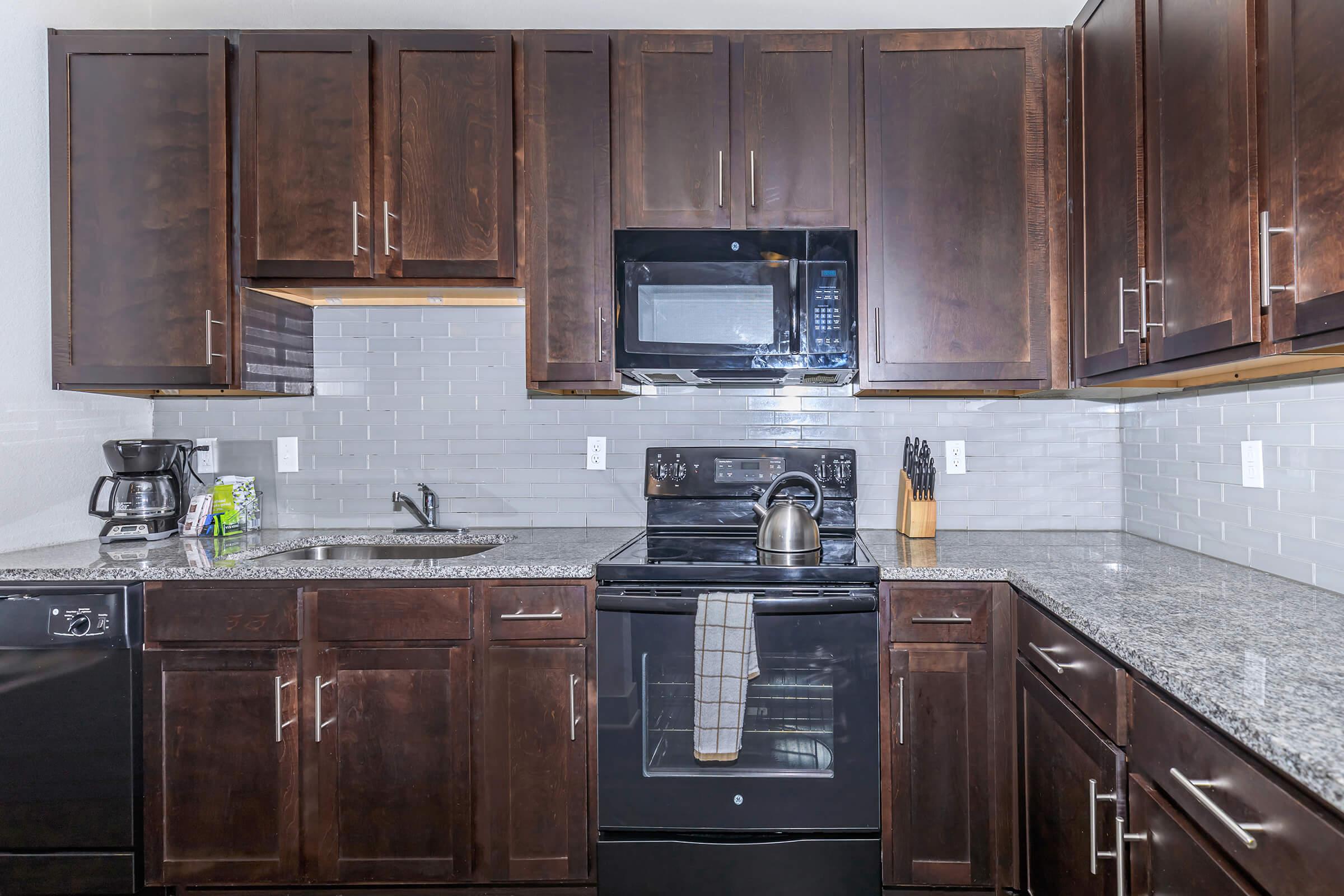 a kitchen with stainless steel appliances and wooden cabinets