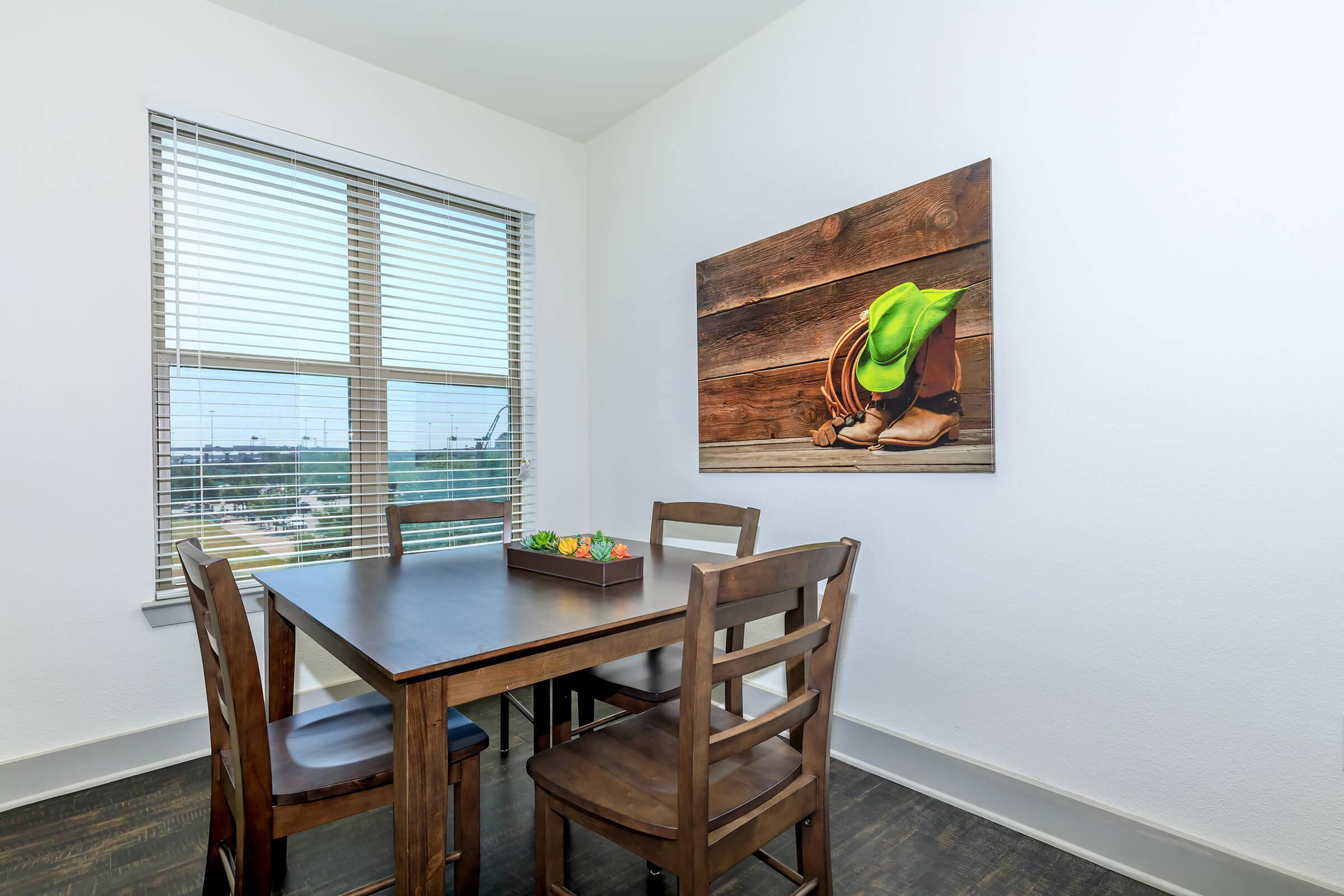 a dining room table in front of a window