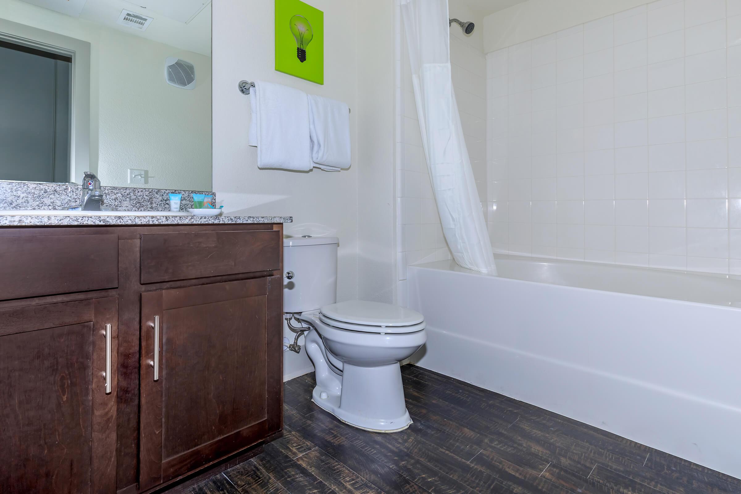 a large white tub next to a shower