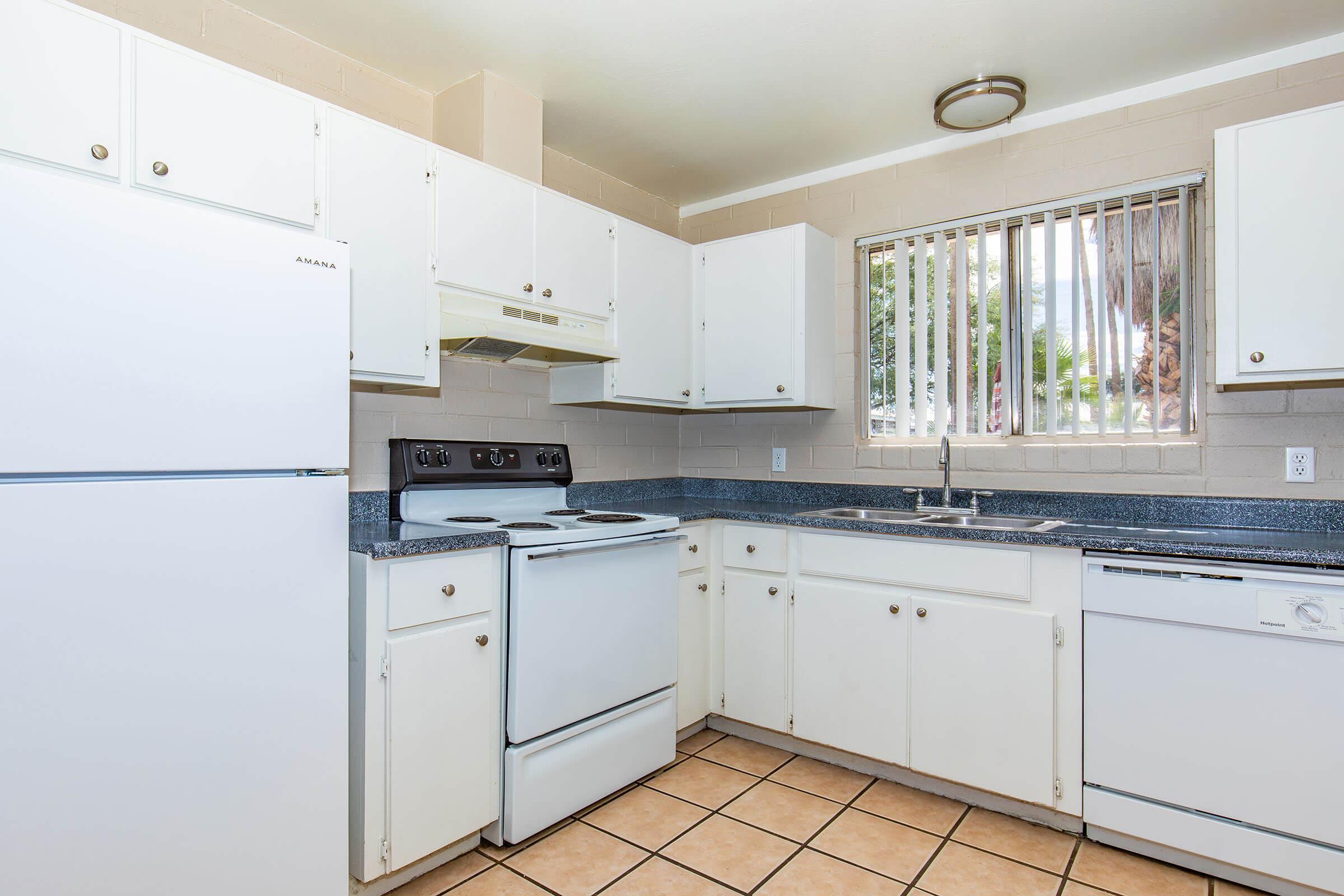 a kitchen with a stove and a refrigerator