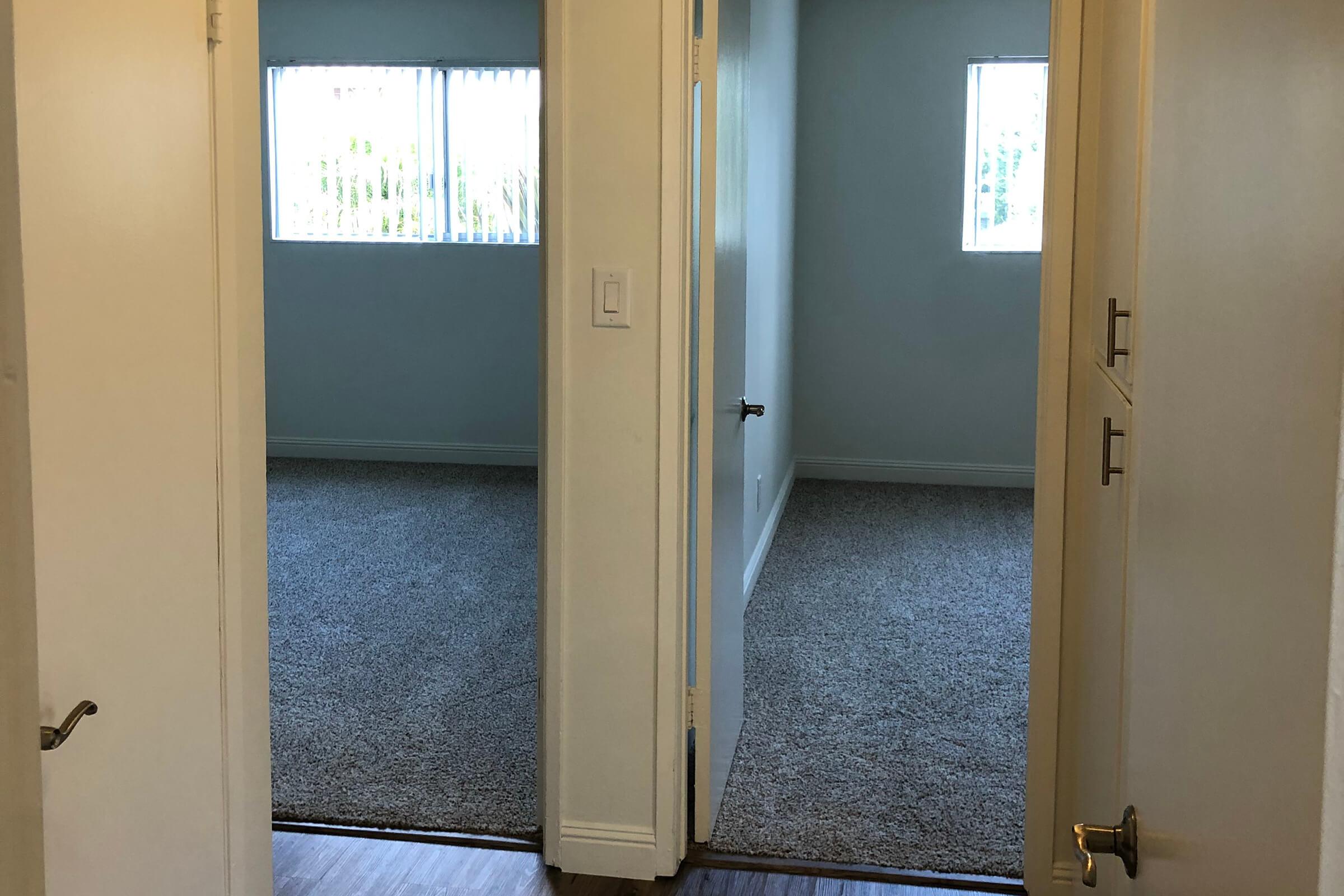 Open bedroom doors with carpet