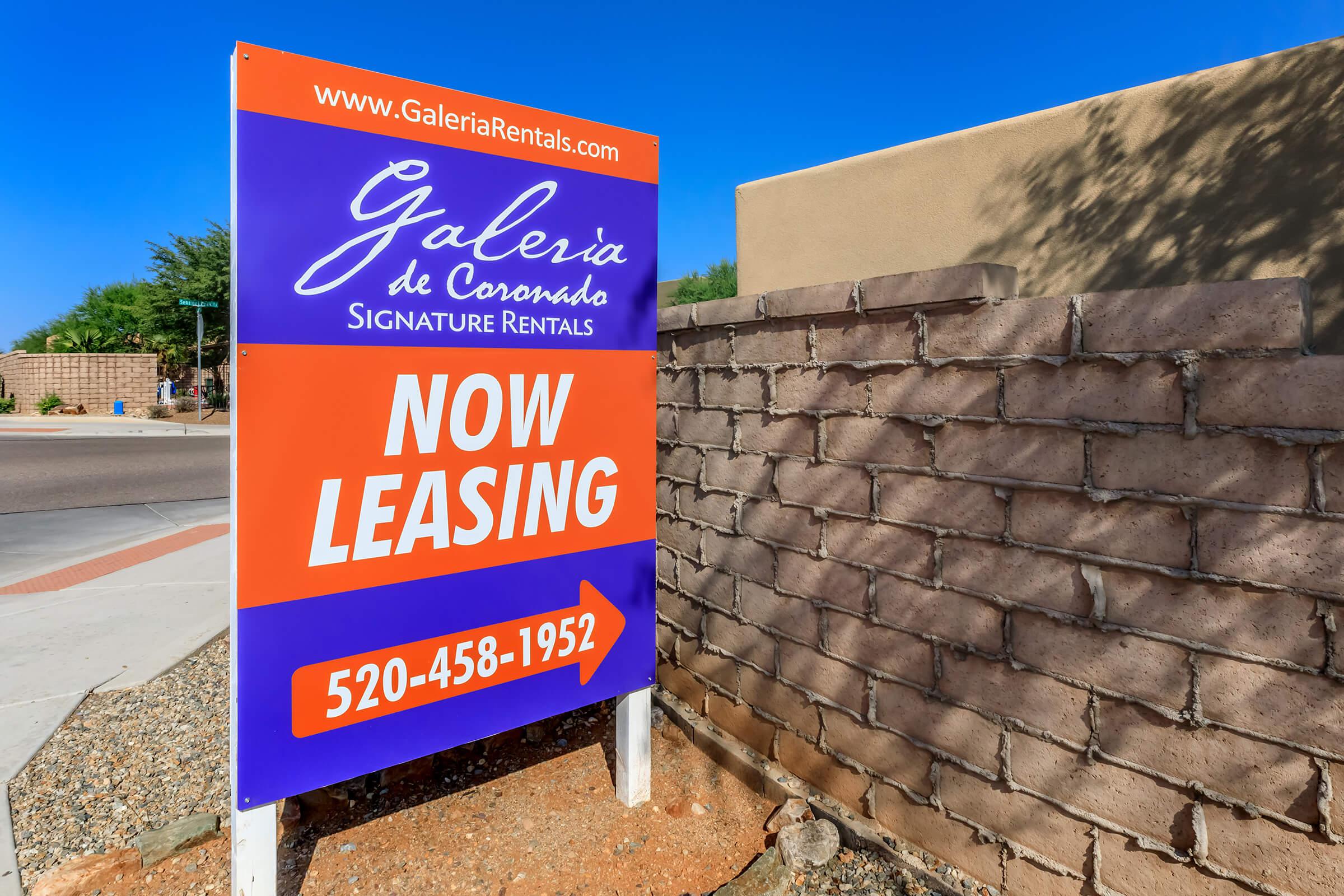 a sign in front of a brick building