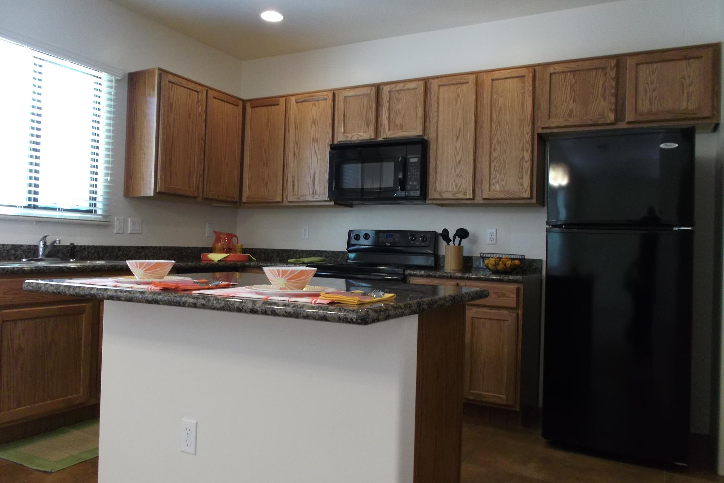 a kitchen with stainless steel appliances and wooden cabinets