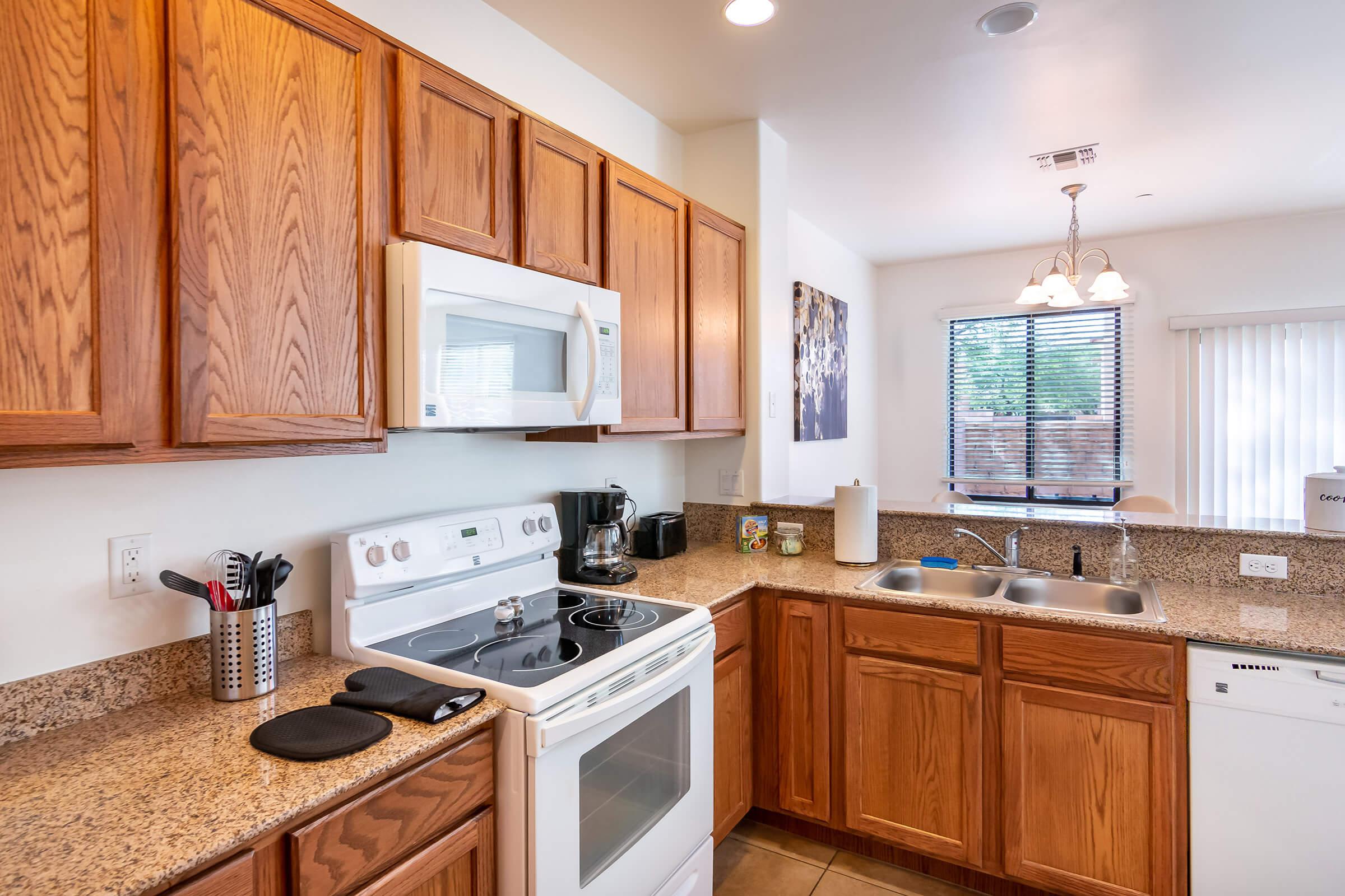 a kitchen with a stove a sink and a microwave