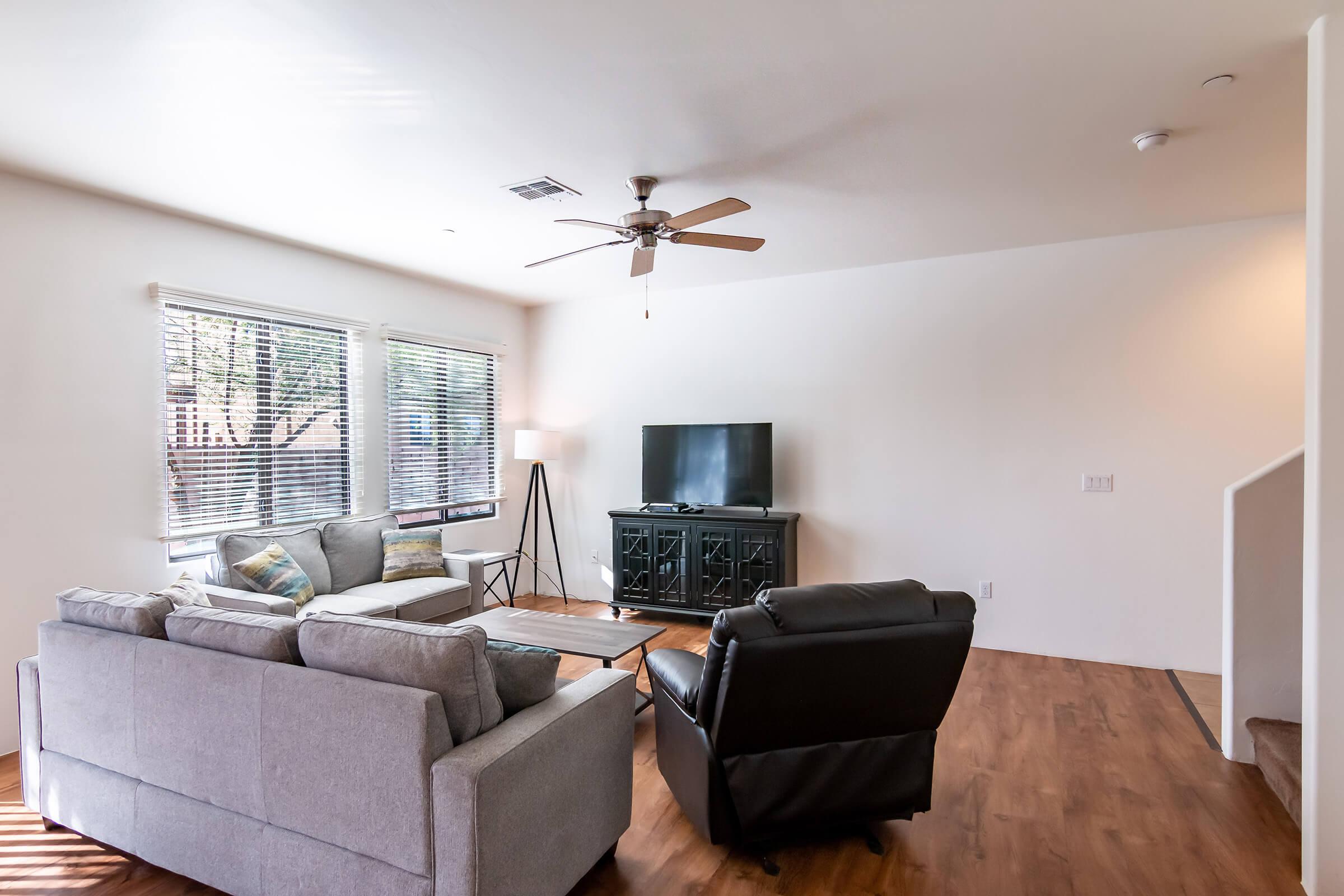 a living room filled with furniture and a large window