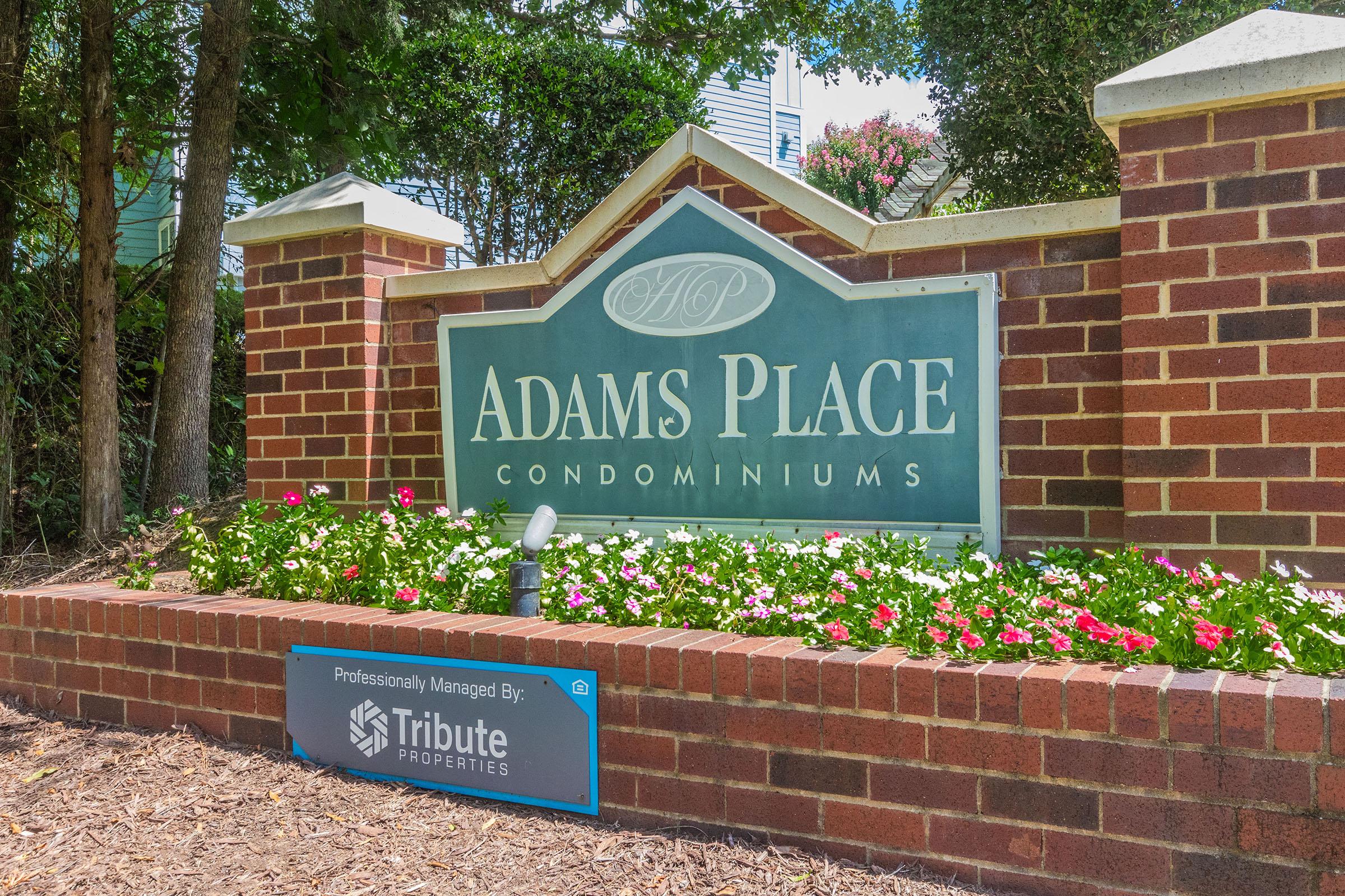 a sign in front of a brick building