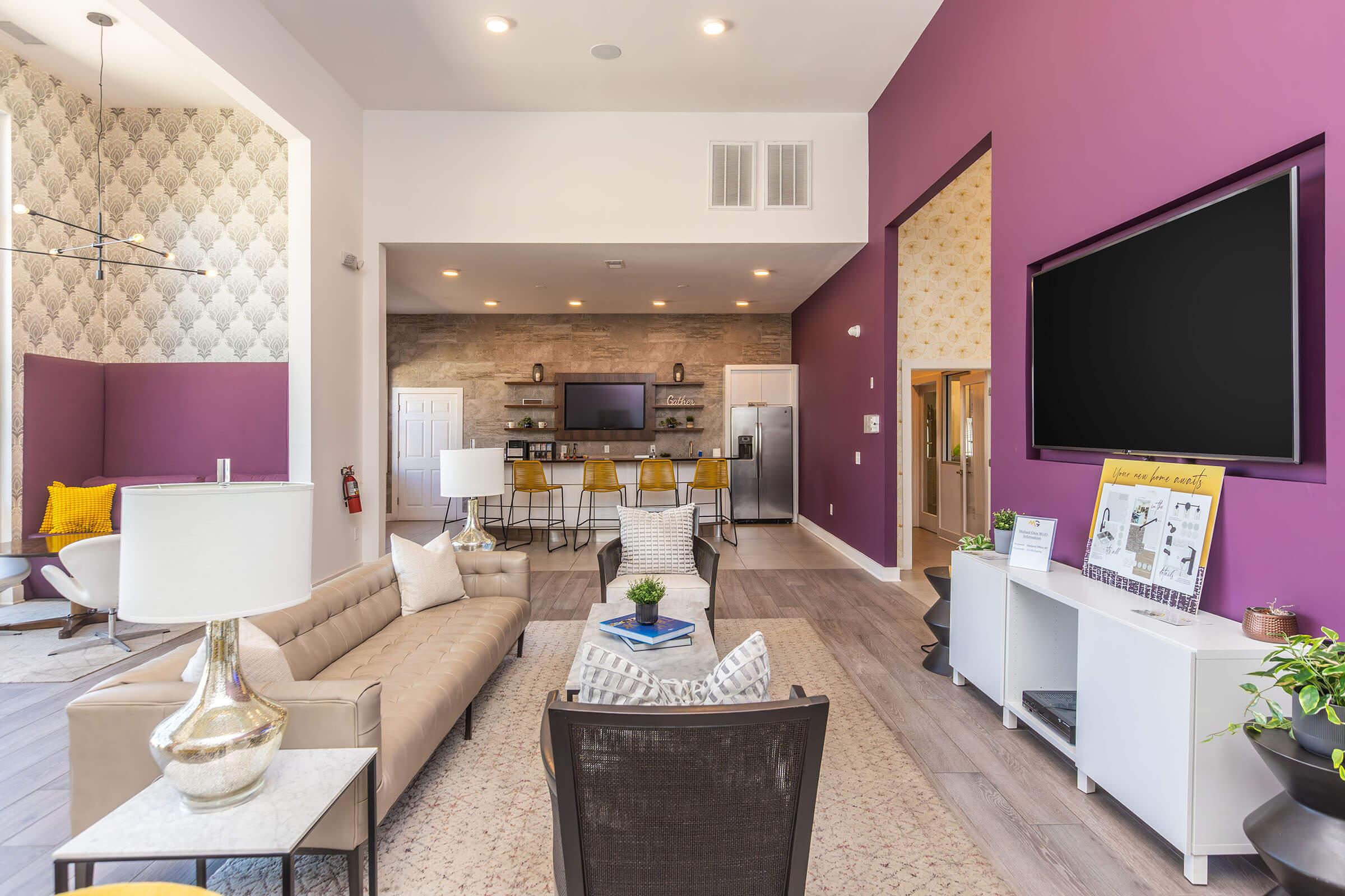 a living room filled with furniture and a flat screen tv