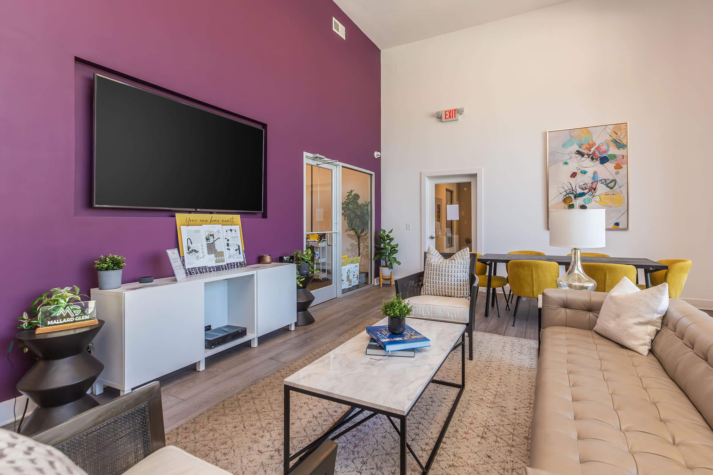 a living room filled with furniture and a flat screen tv