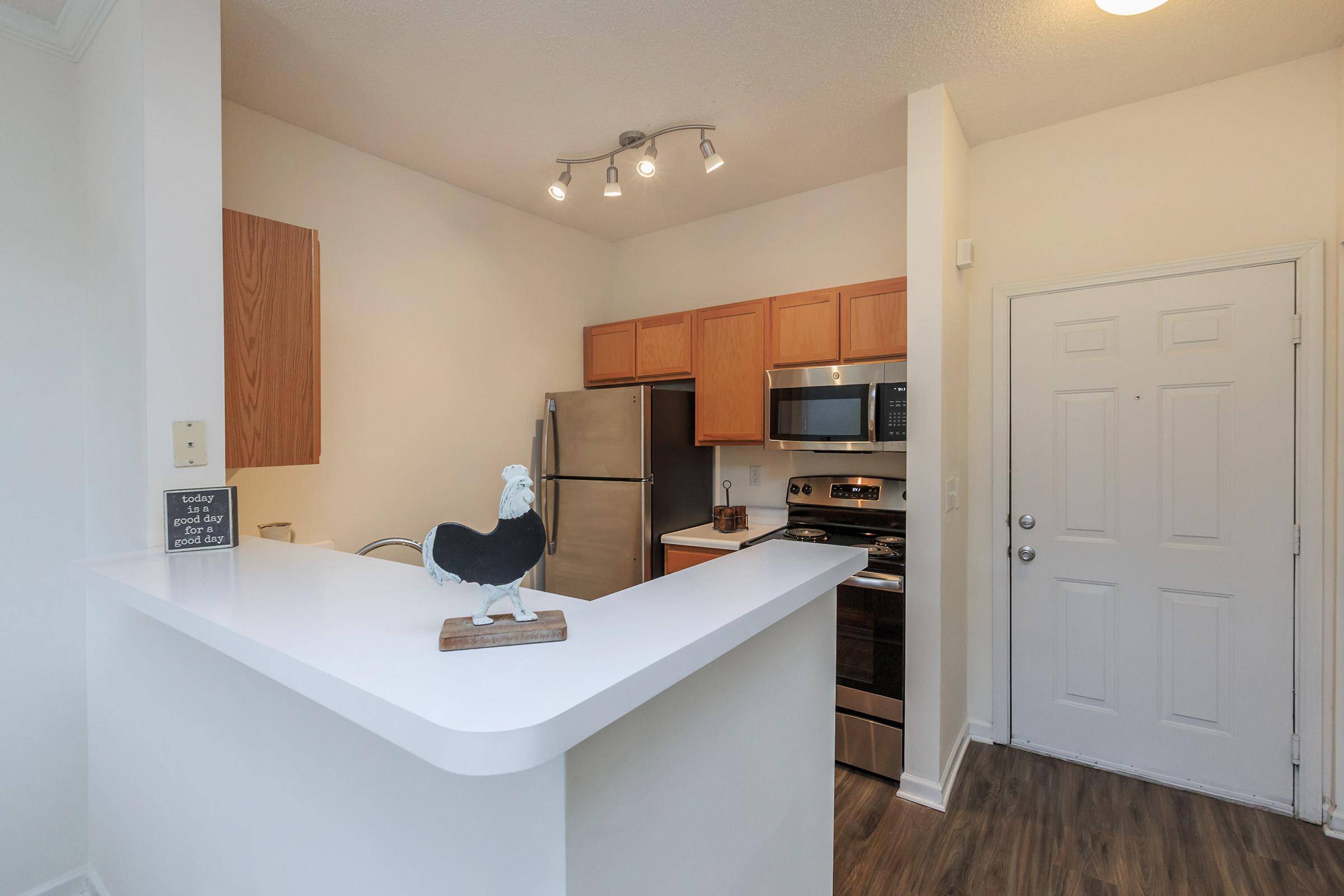 a kitchen with a sink and a mirror