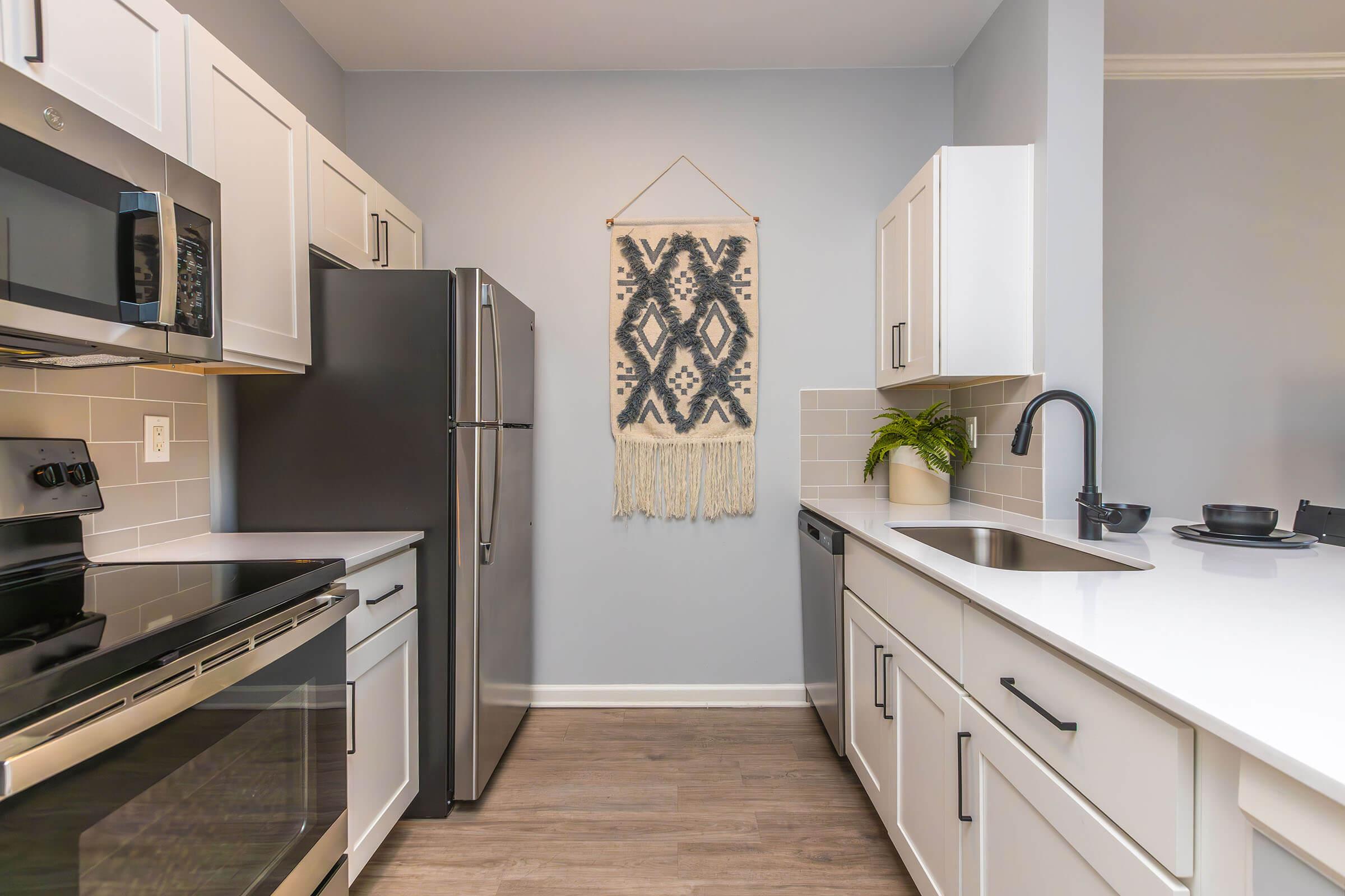 a kitchen with a stove a sink and a microwave