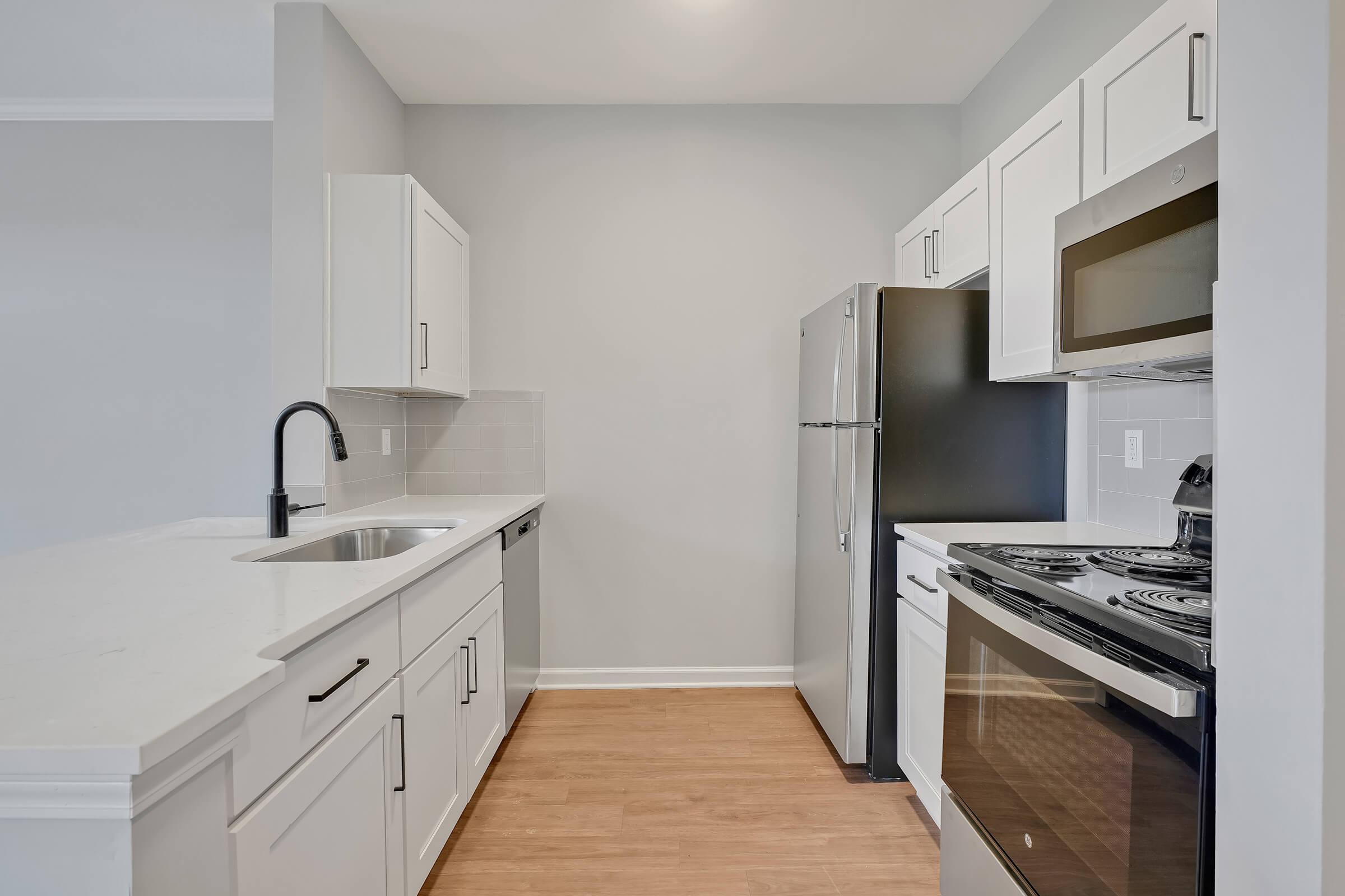 a kitchen with a stove sink and refrigerator