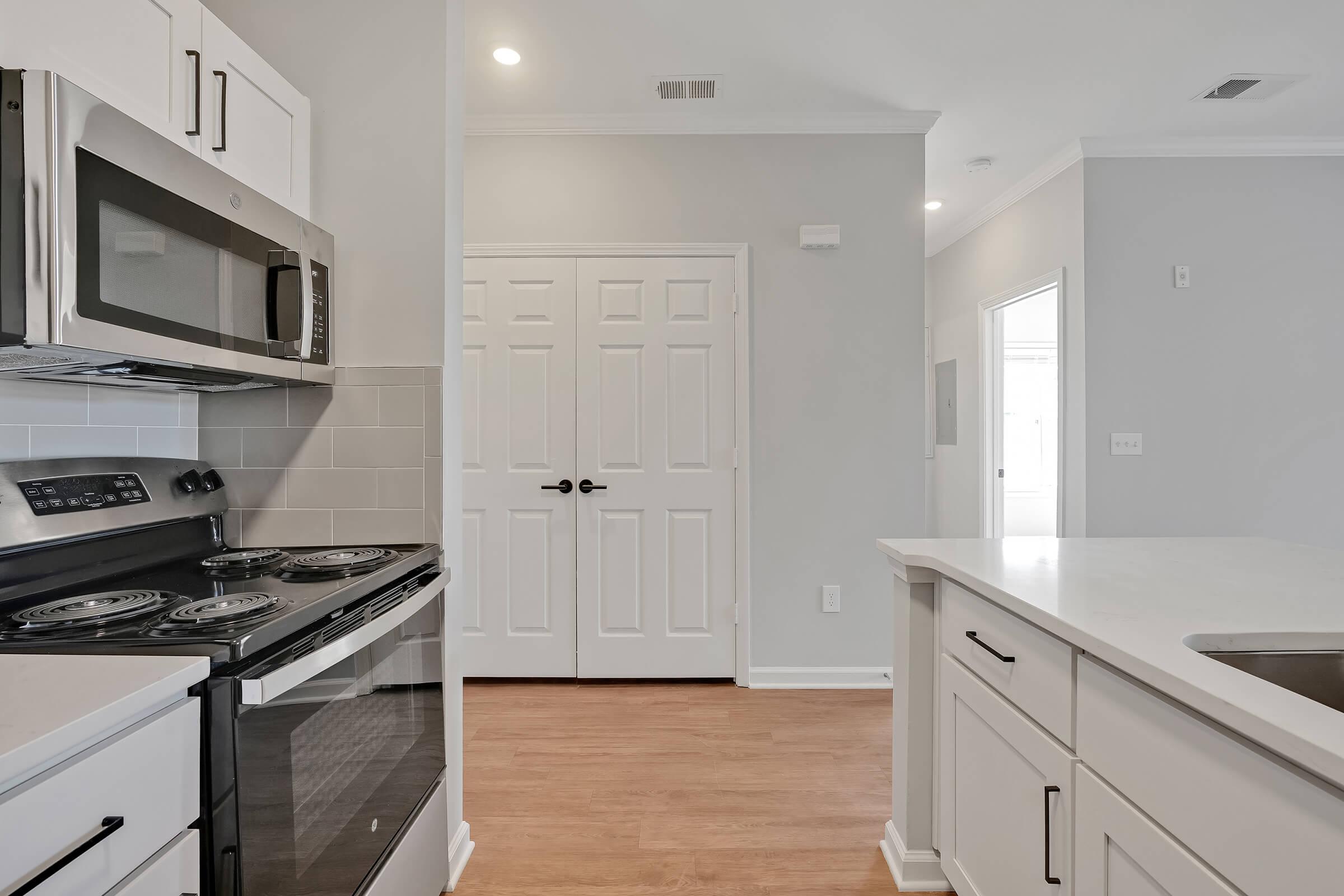 a stove top oven sitting inside of a kitchen