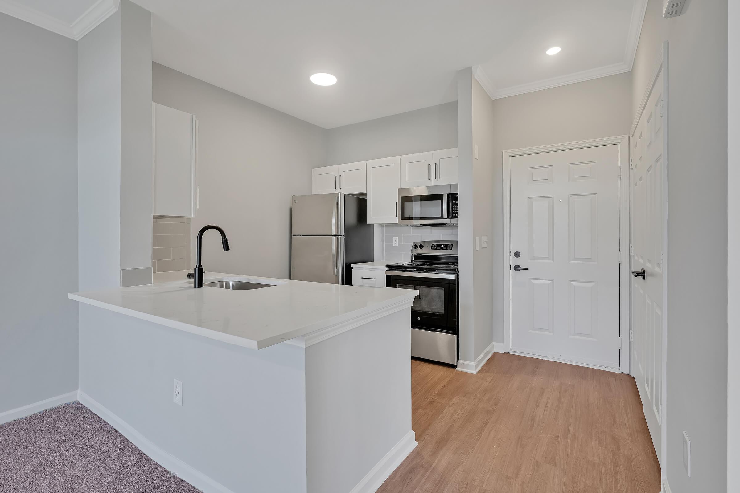 a kitchen with a sink and a refrigerator