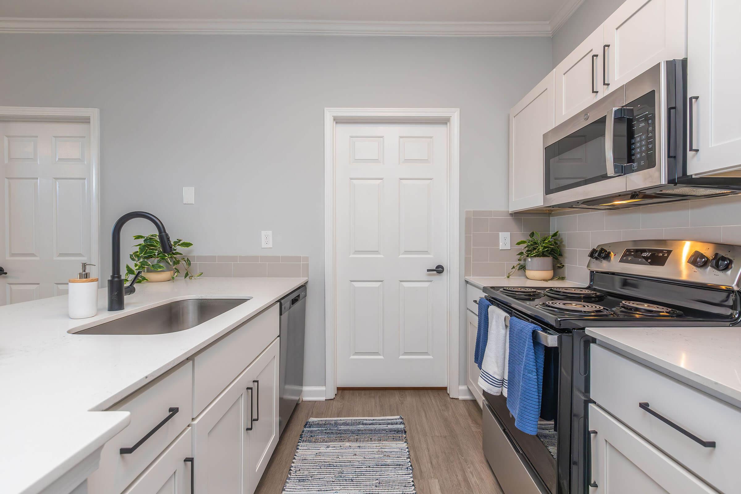 a stove top oven sitting inside of a kitchen