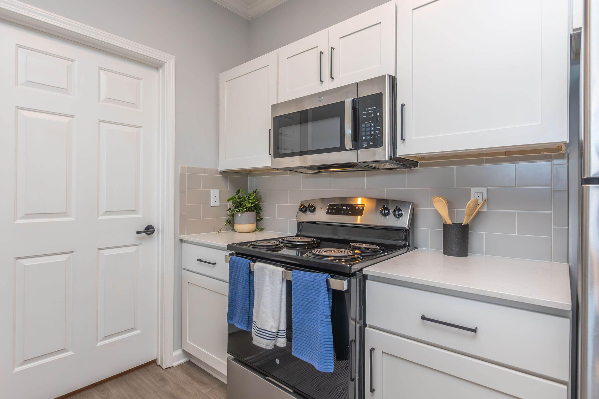 a stove top oven sitting inside of a kitchen