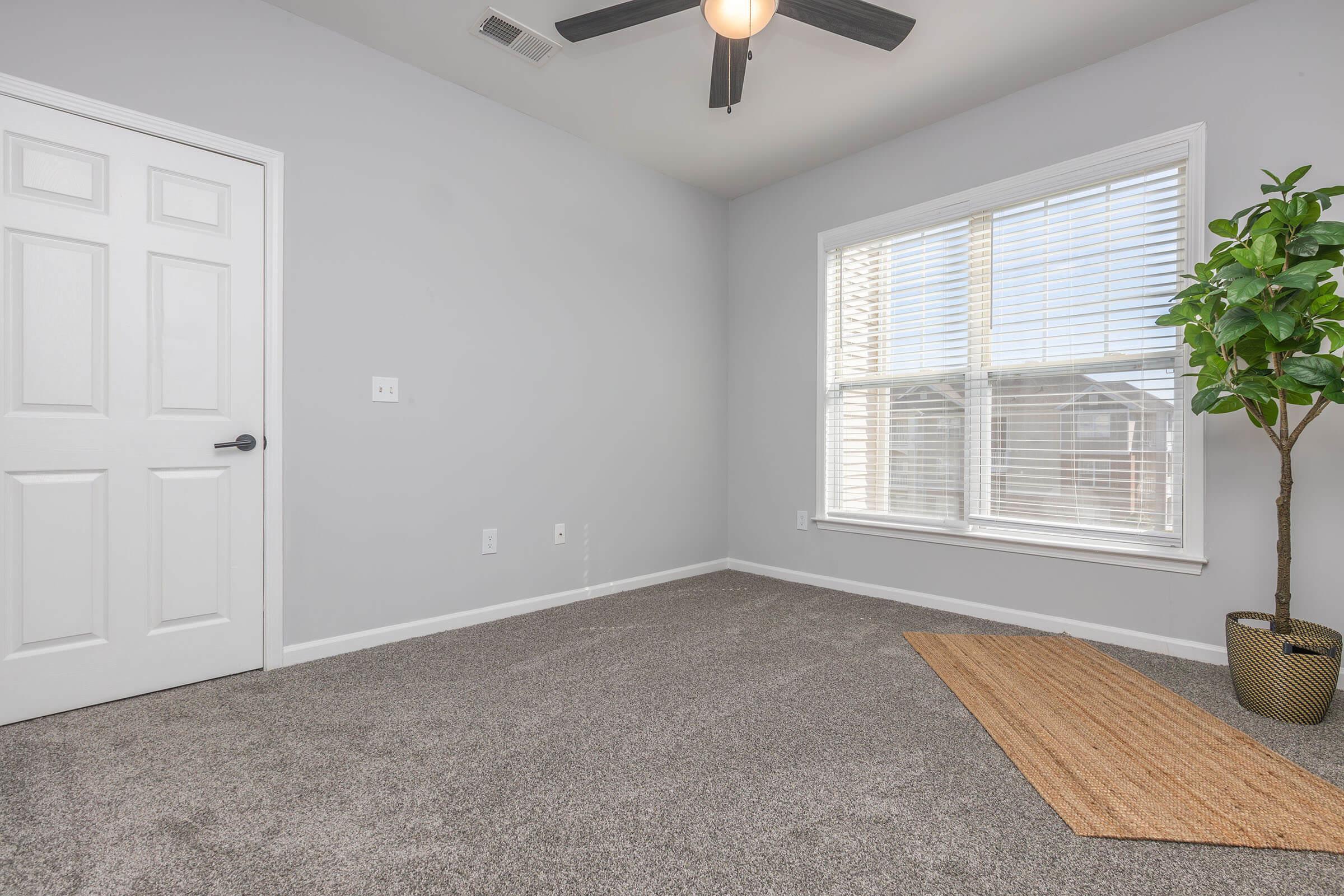 a room filled with furniture and a large window