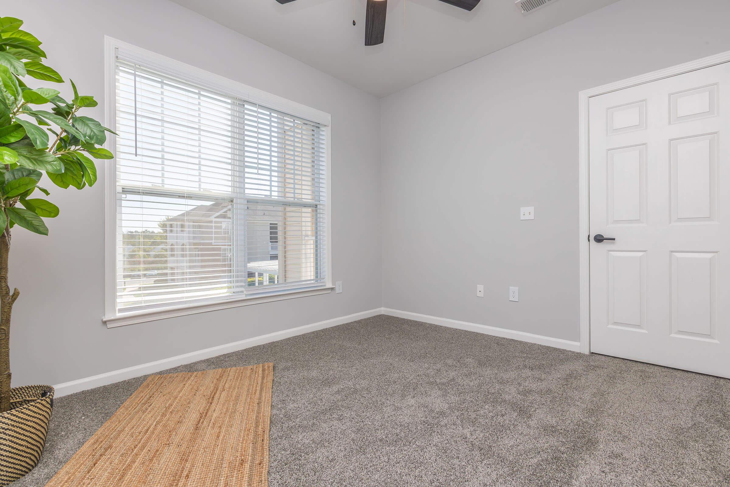 a bedroom with a large window