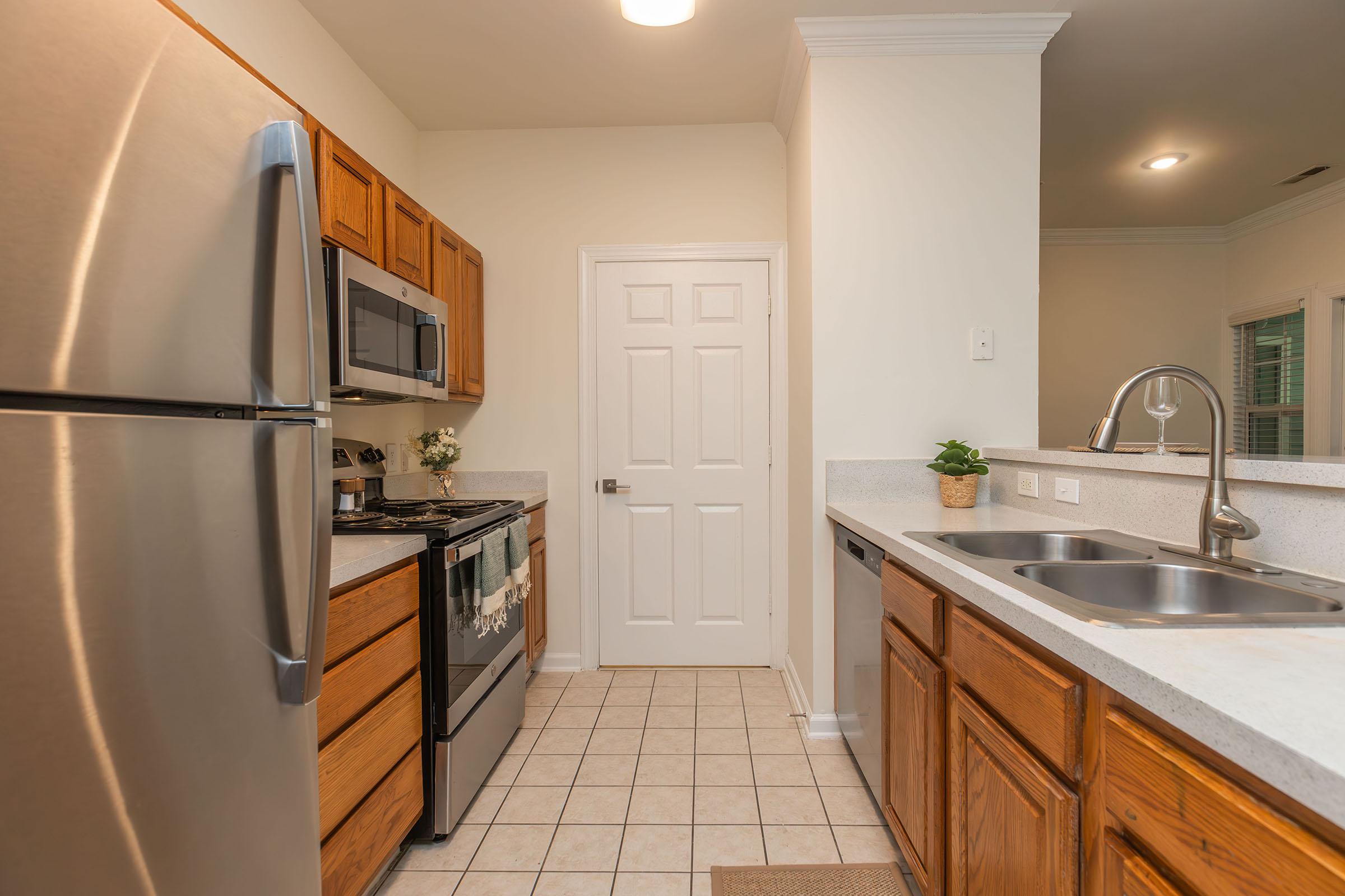 a kitchen with a sink and a refrigerator