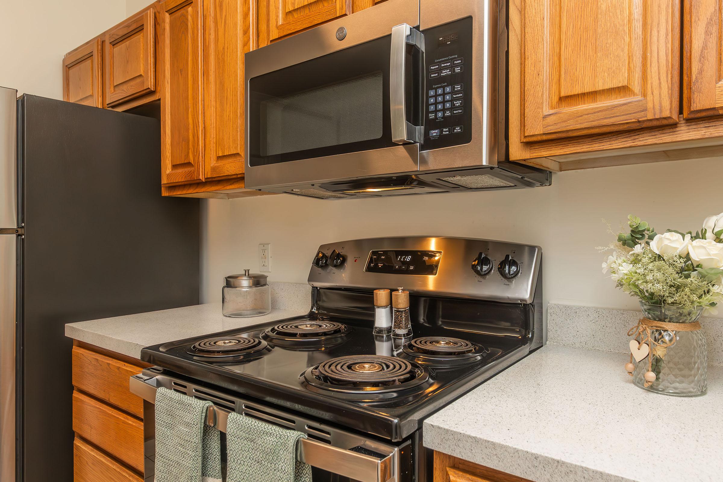 a stove top oven sitting inside of a kitchen