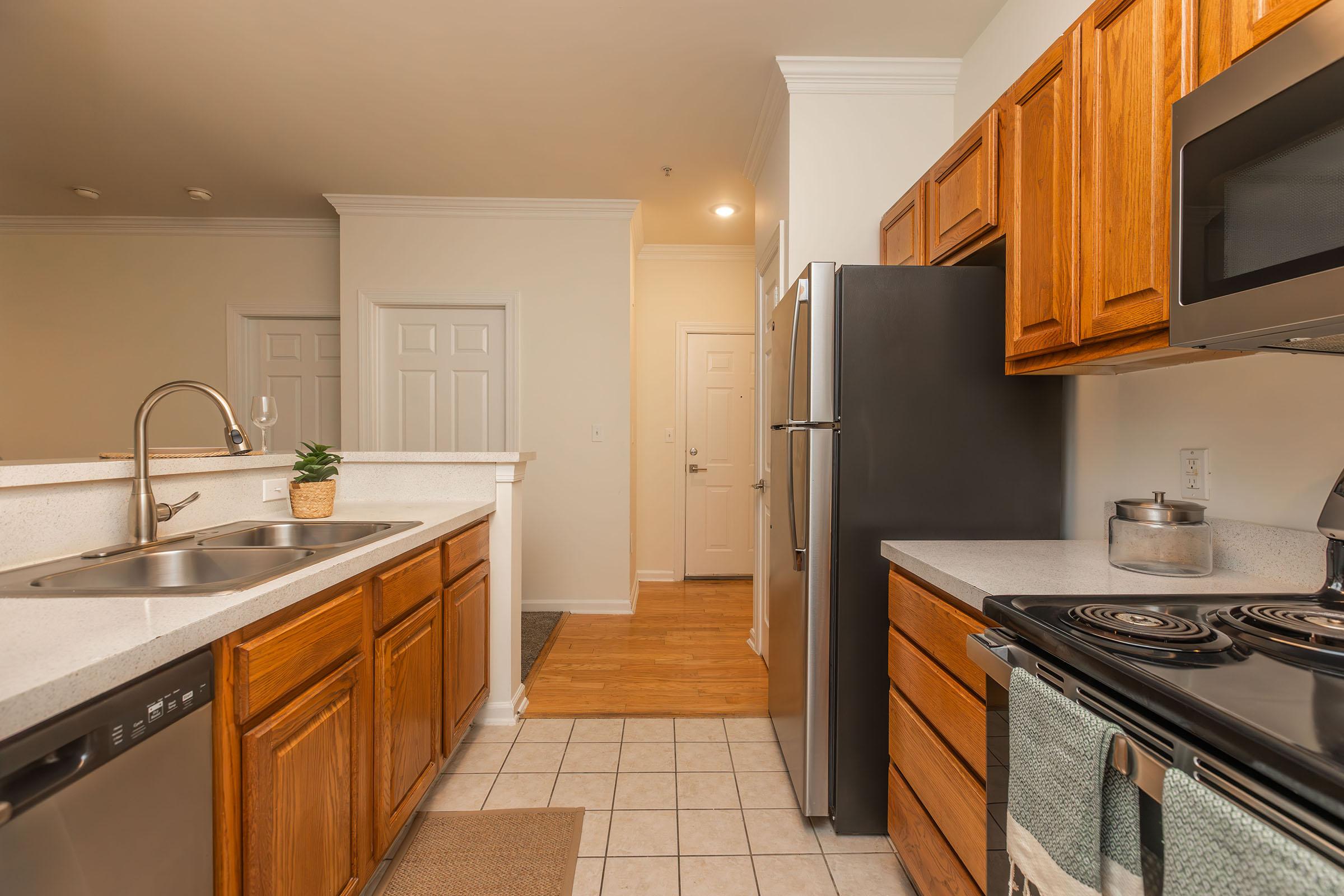 a kitchen with stainless steel appliances and wooden cabinets