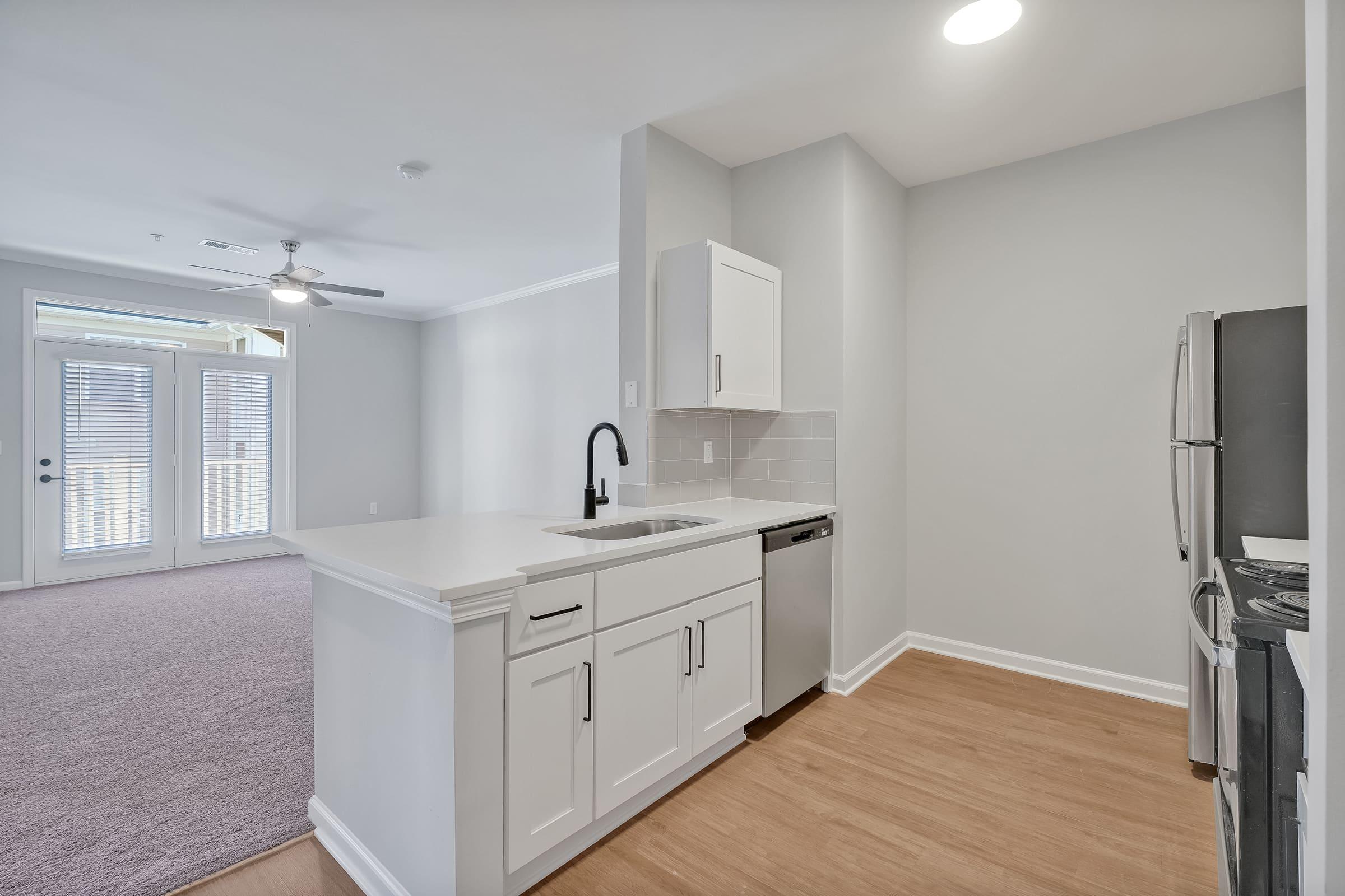 a kitchen with a sink and a refrigerator