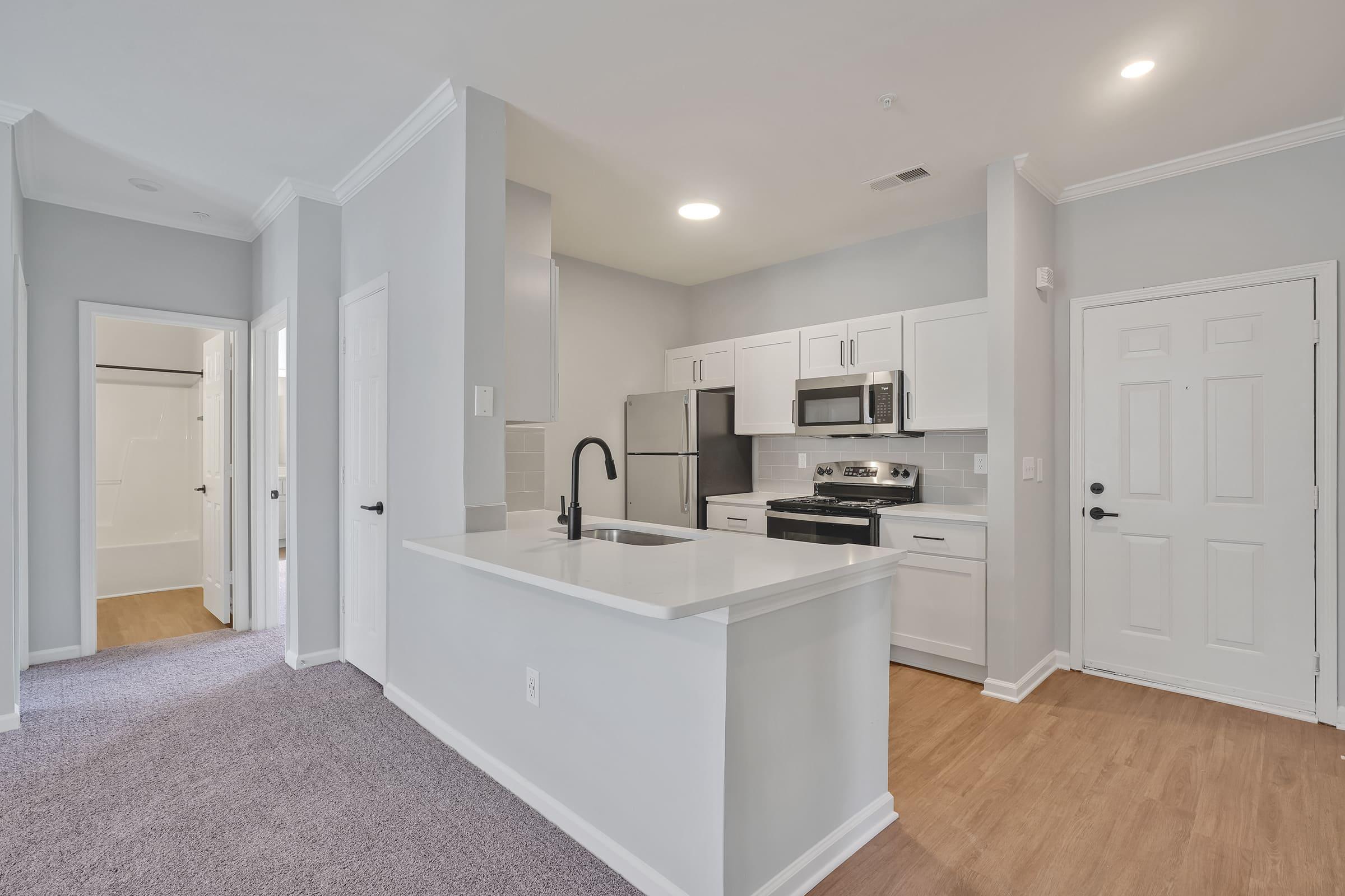 a kitchen with a sink and a mirror